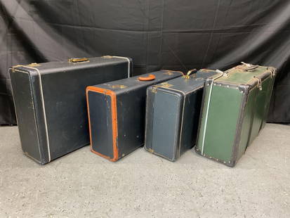 Collection of four Vintage Travel Cases: A group of four vintage hard-sided travel cases, each featuring metal latches and leather or bakelite handles. The cases show signs of wear consistent with age and use, with variations in color includ