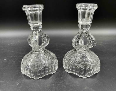 Pair of Crystal Compote Dishes on Pedestal Stems: Descriptions: Set of two ornate footed compotes with floral and swirl cut design, standing on curved loop stems and faceted bases. Medium: Pressed and cut crystal