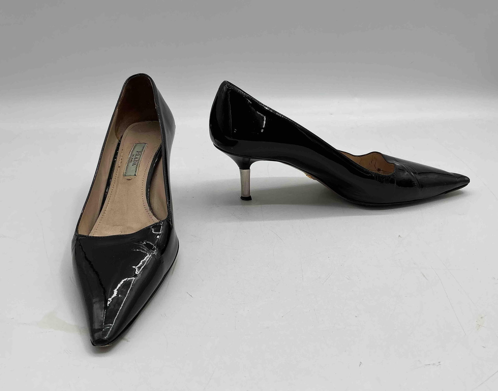 Prada Black Patent Leather Pointed-Toe Pumps, Size 37: Authentic Prada heels in black patent leather with pointed toe and leather sole. Size 37. Some visible wear to heel. Medium: Patent leather