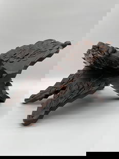 Hand-Carved Wooden Book or Tablet Stand: This is a hand-carved wooden folding stand, traditionally used to hold books, tablets, or religious texts. The stand features detailed floral carvings and a dark wood finish with natural variations an