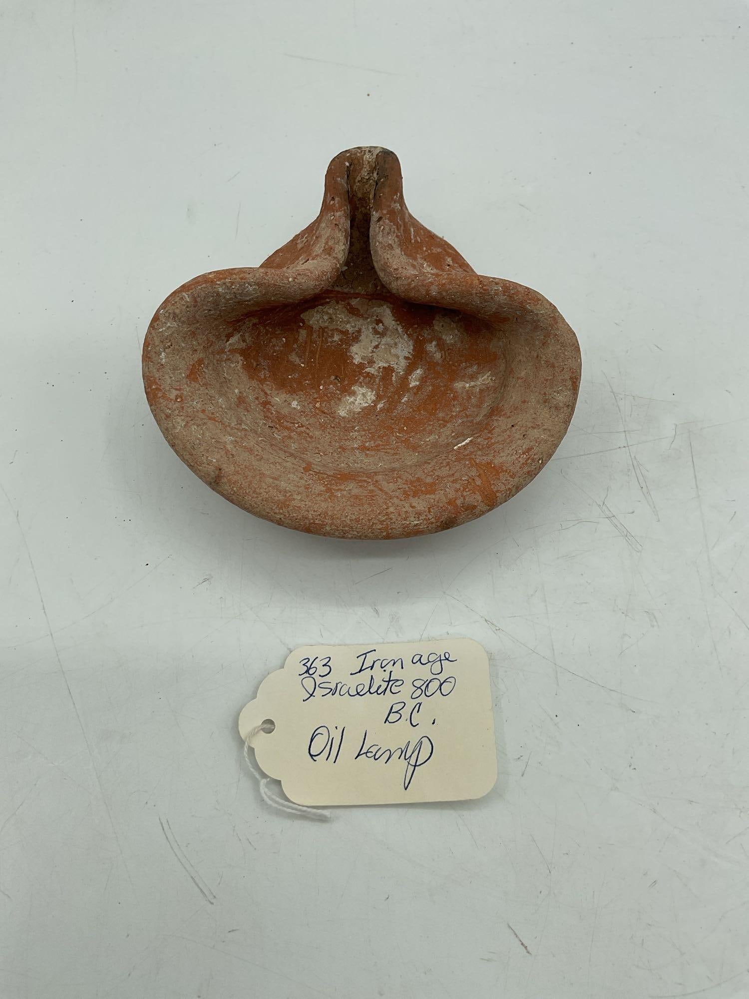 Iron Age Israelite 800 B.C. Oil Lamp: An oil lamp from the Iron Age, dated around 800 B.C. The lamp is made of terracotta and features a typical design with a central reservoir and a spout for the wick. Medium: Terracotta