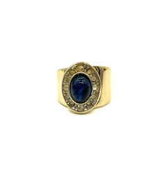 Yellow 18 kt Gold Ring with Cabochon Blue Sapphire and Diamond Halo