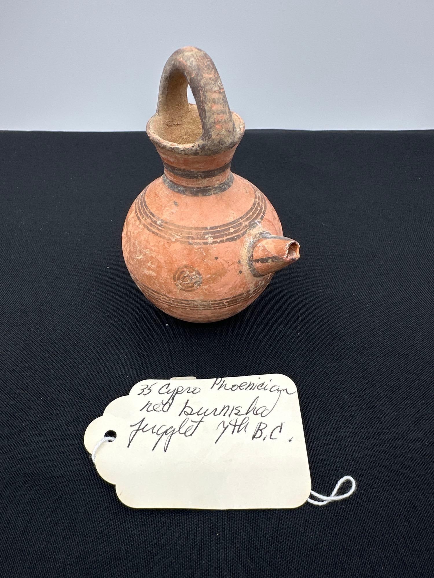 35 - Cypro Phoenician red burnished Jugglet 7th B.C.: Small red burnished juglet with a spout and arched handle, dated to 7th century B.C. Medium: Terracotta
