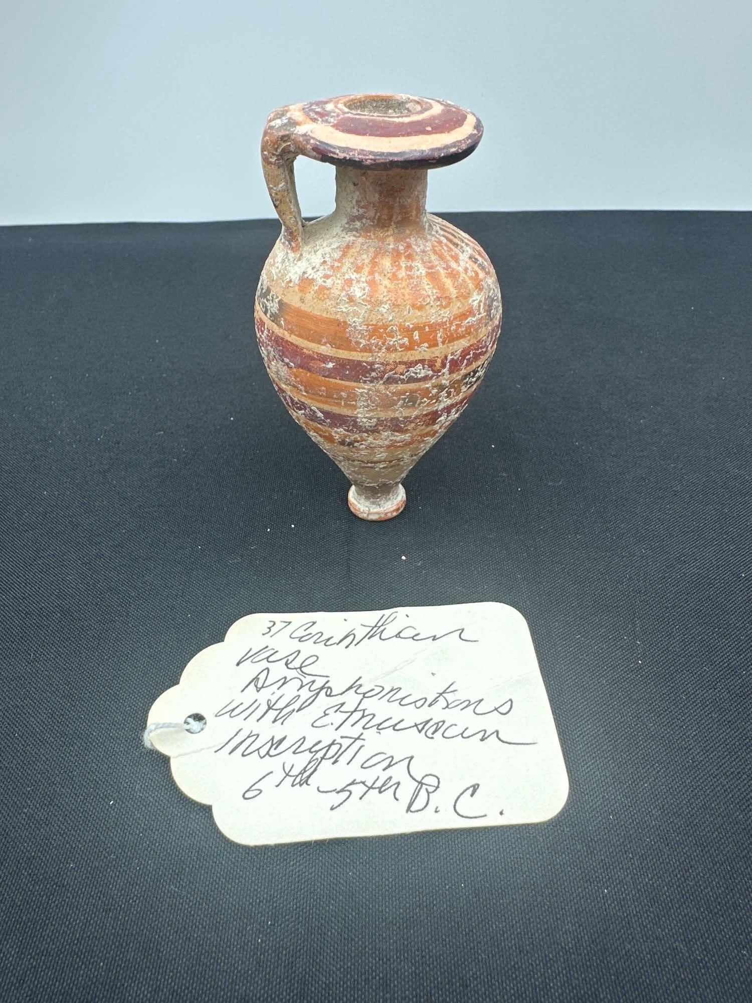 37 - Corinthian Vase 6th-5th B.C.: Small wheel-thrown amphora with red and black painted bands and a visible Etruscan inscription. Medium: Terracotta