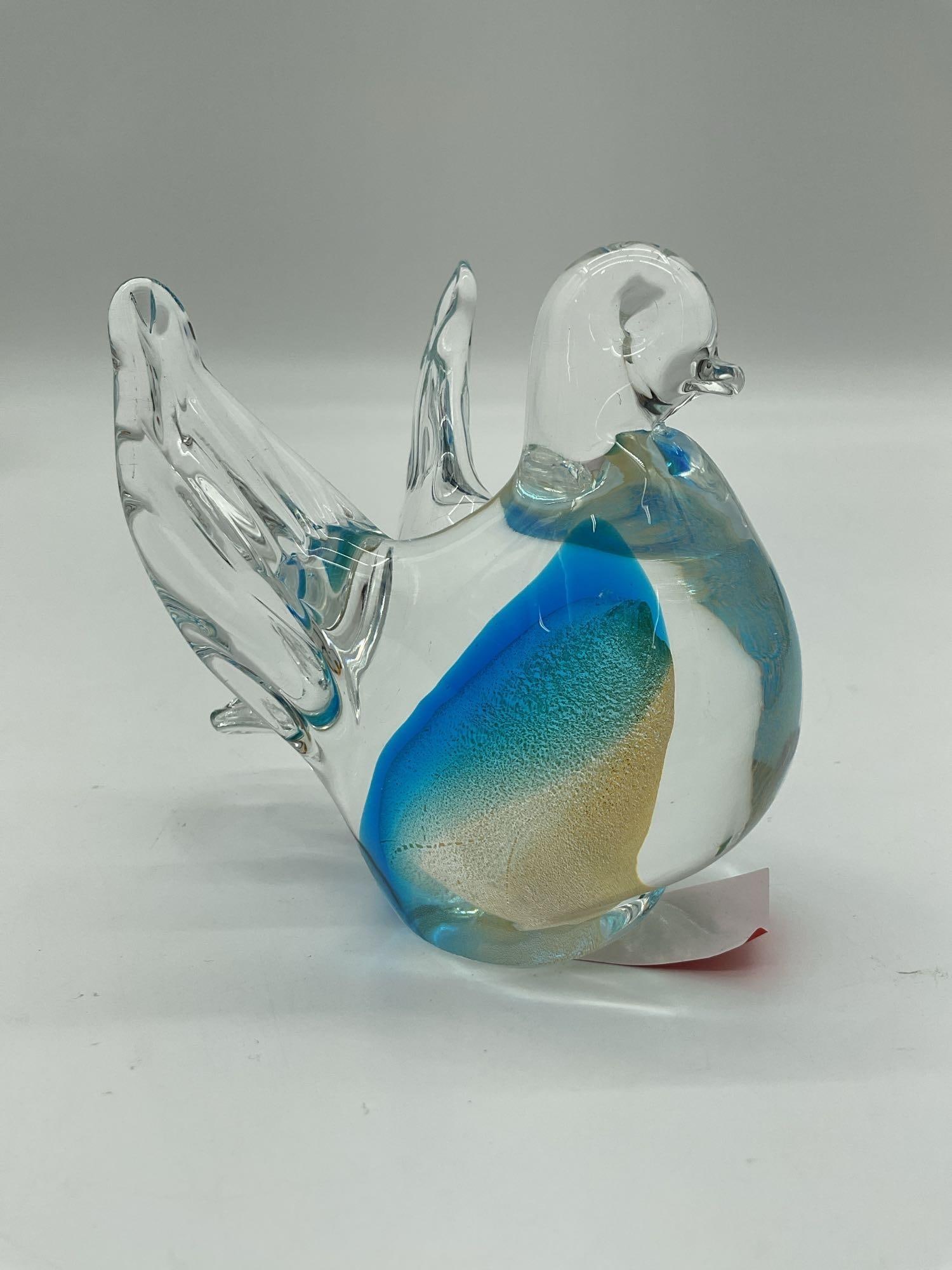 Murano Glass Bird Figurine: Clear glass bird with outstretched wings, featuring vibrant internal swirls of blue and gold. Elegant and decorative, with no visible artist signature. Dimensions: H4in L4in W3in Medium: Blown glass w