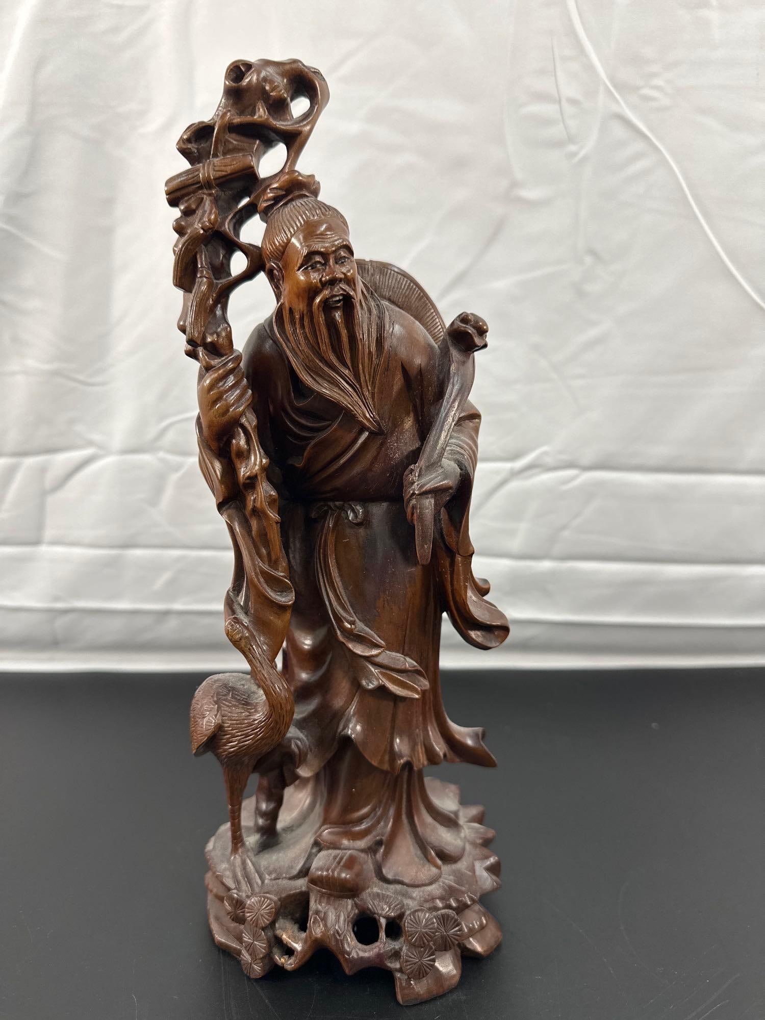 Antique Chinese Carved Wood Figurine of Shou Lao, God of Longevity": This is a beautifully carved wooden figurine depicting Shou Lao, the Chinese Taoist deity of longevity. The figure is portrayed with traditional attributes: a long beard, a staff with a gnarled top, a
