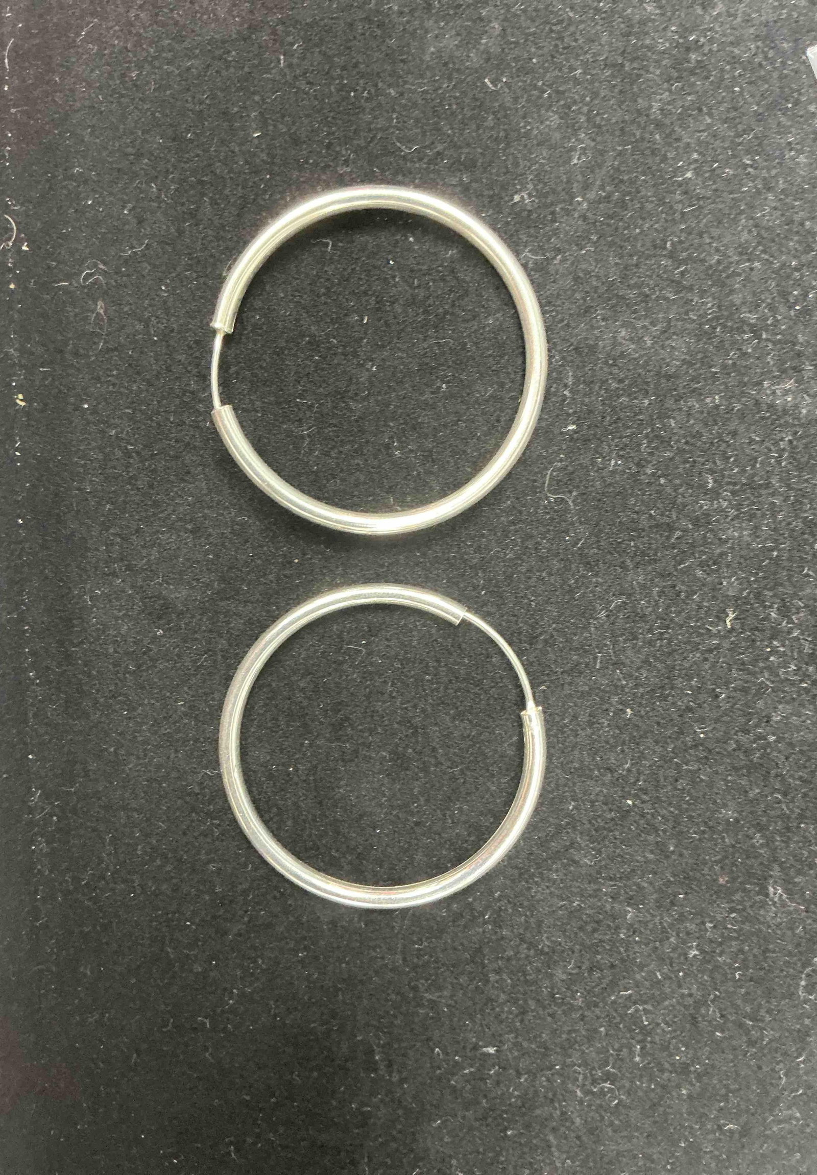 Sterling Silver 925 Hoop Earrings, 2" Diameter – 6.75g: Elegant oversized hoop earrings crafted in sterling silver, stamped 925, with a sleek polished finish. Measuring approximately 2 inches in diameter and weighing a combined 6.75 grams, these hoops