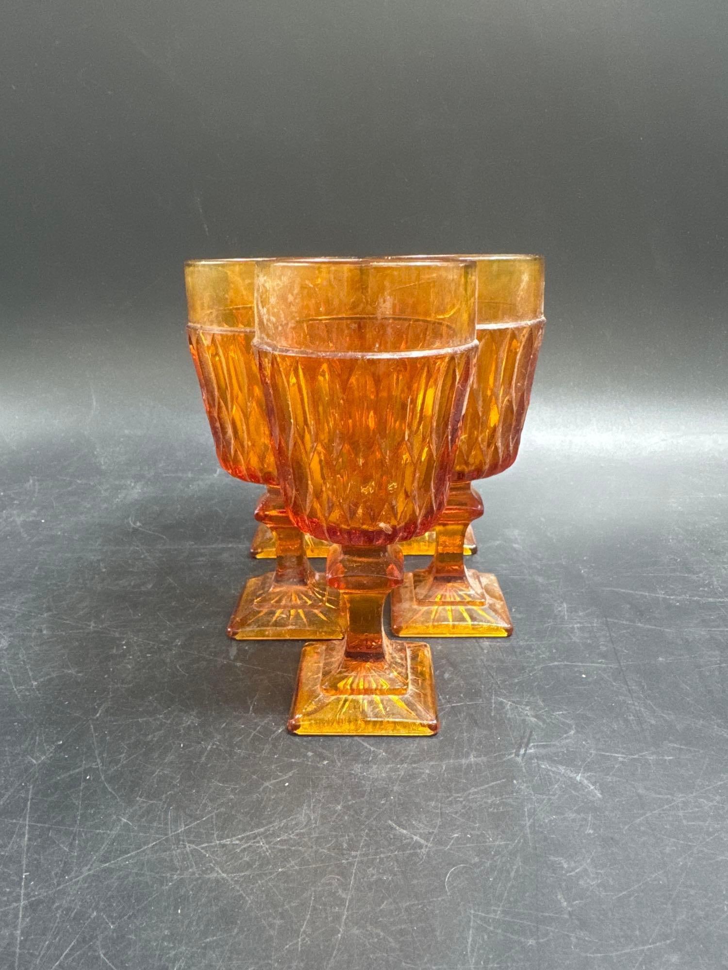 Set of 5 Vintage Amber Glass Goblets: A matching set of five vintage amber-colored pressed glass goblets featuring a diamond-patterned body with vertical ribbed accents and sturdy square bases. Their bold retro style makes them ideal for
