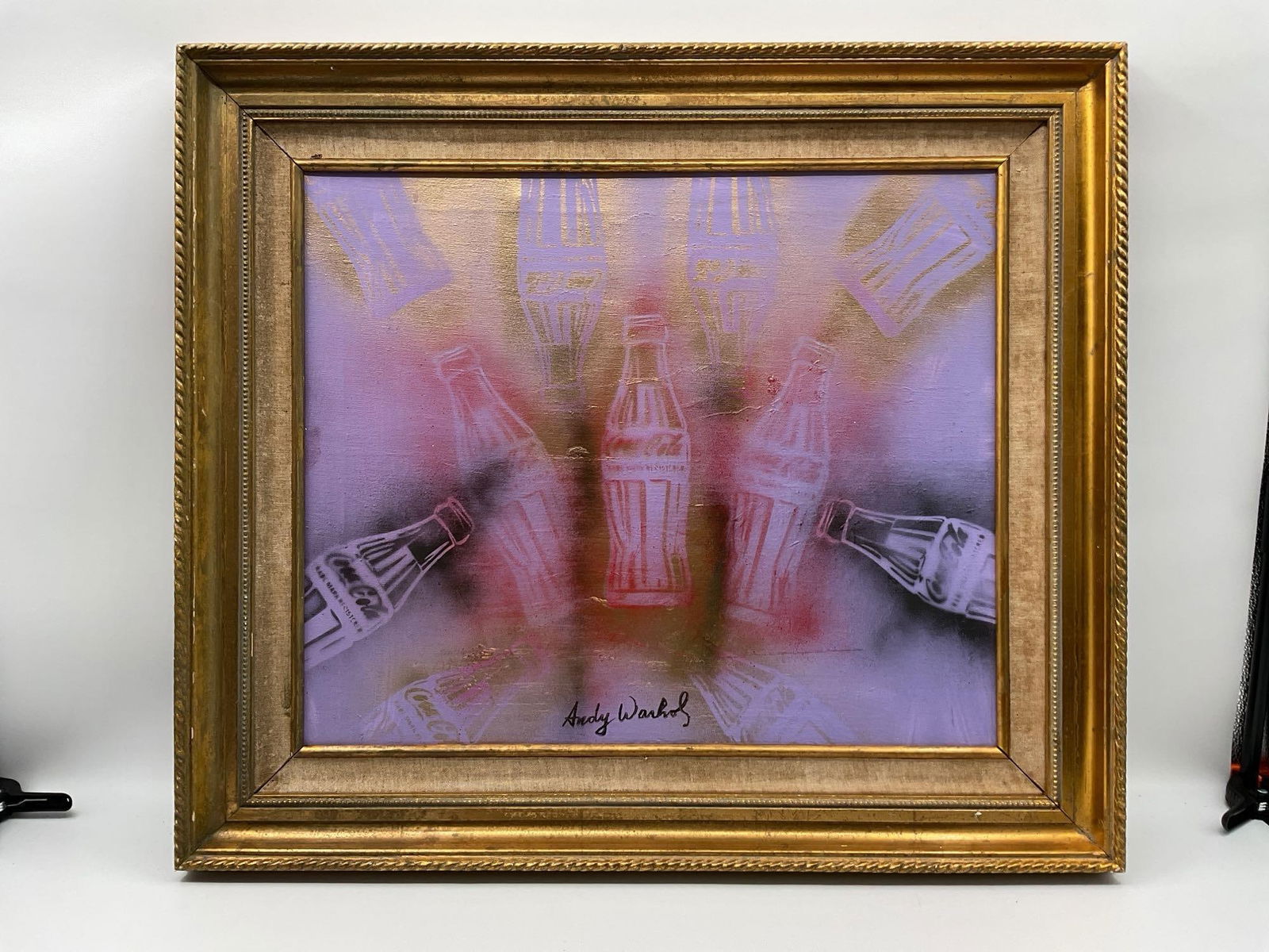 Coca-Cola Bottles In the Style of Andy Warhol: Description: Mixed media work on canvas featuring iconic Coca-Cola bottle motifs, with spray paint and stencil-like repetition. The piece is attributed to Andy Warhol and dated ca. 1978–81, reflecti