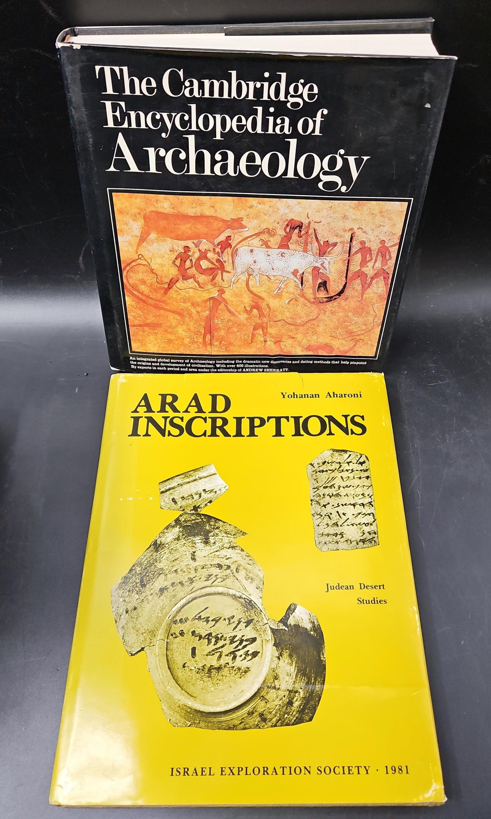 The Cambridge Encyclopedia of Archaeology and Arad Inscriptions by Yohanan Aharoni: A lot of two archaeological reference works. Includes The Cambridge Encyclopedia of Archaeology (large hardcover with dust jacket, richly illustrated survey of world archaeology) and Arad Inscriptions