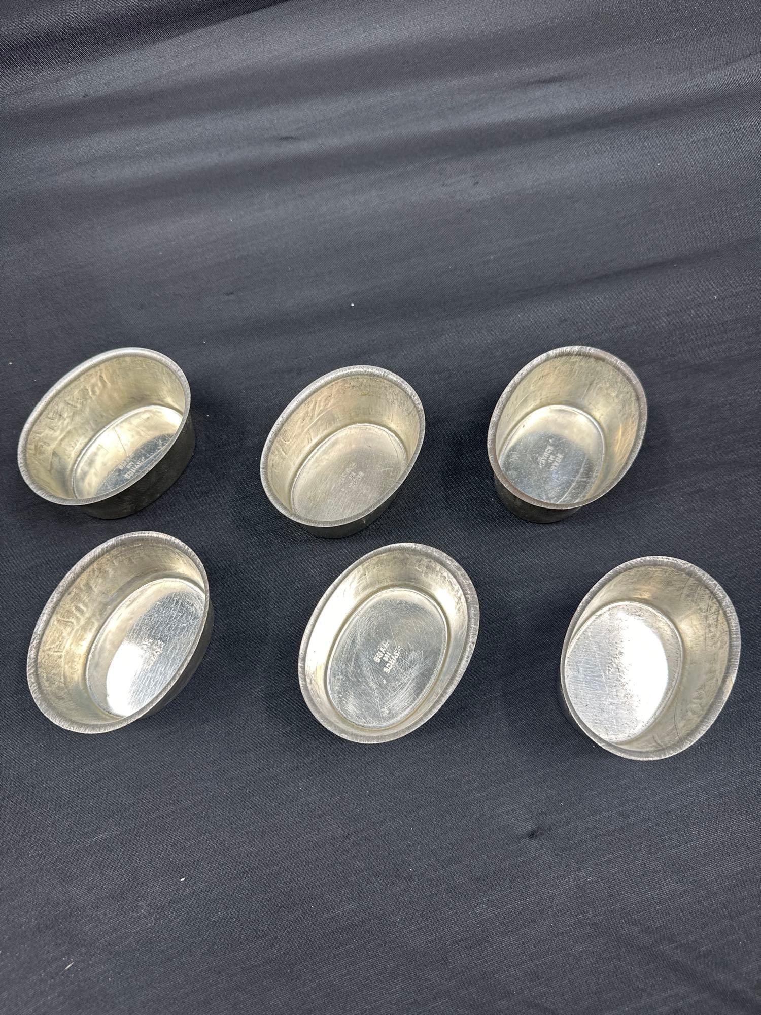 Set of 6 French Pewter Tasting Cups: Group of vintage pewter wine tasting cups with flared rims and ribbed detailing. Marked “Made in France” on the base, these cups were traditionally used in French wine culture for sampling .Di