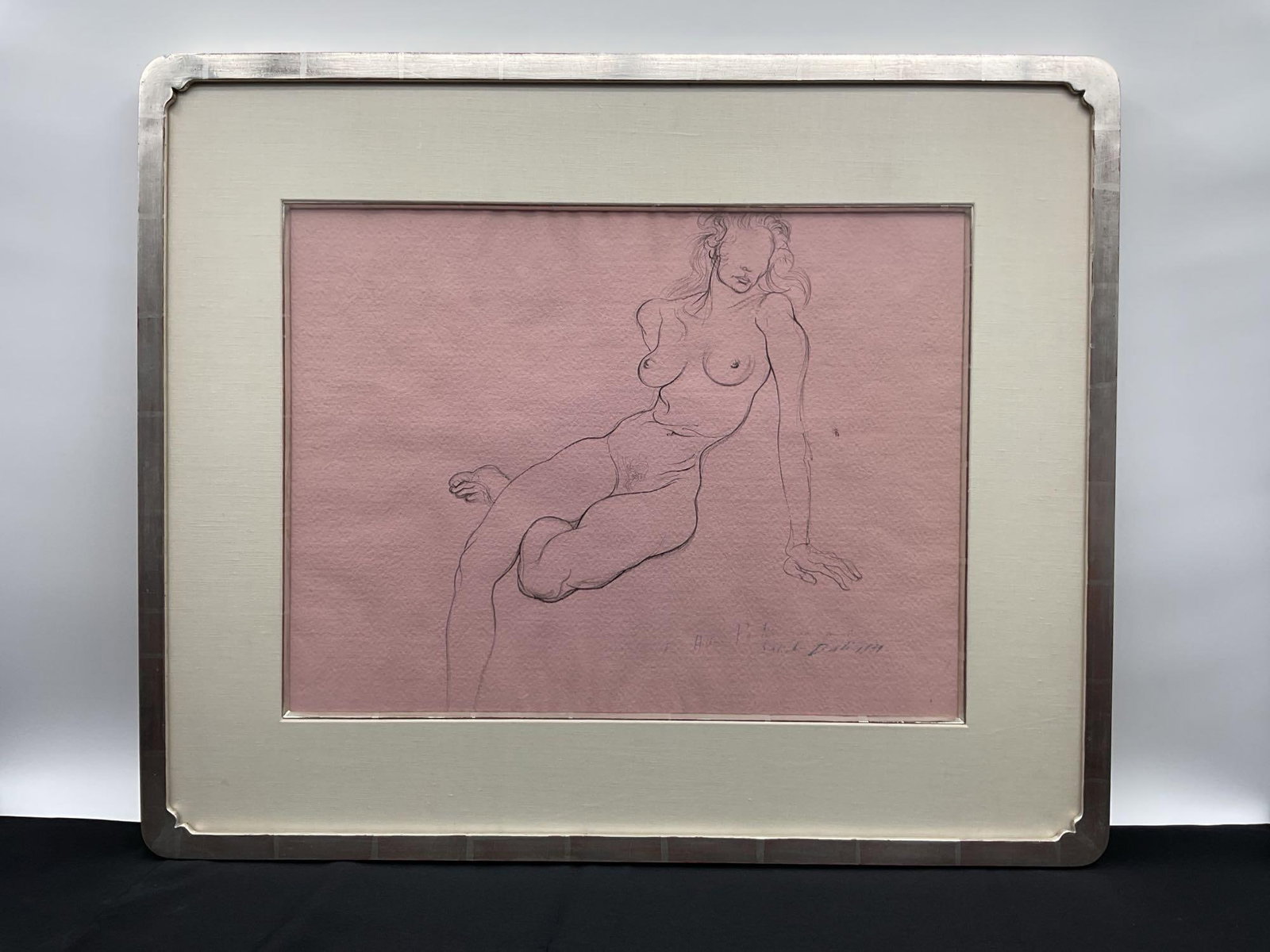 Female Nude Drawing by Salvador Dalí (1939): Description: Original ink brush drawing on pink paper titled "Female Nude," attributed to Salvador Dalí, depicting a stylized, semi-surreal seated female figure. Executed in 1939, this work i