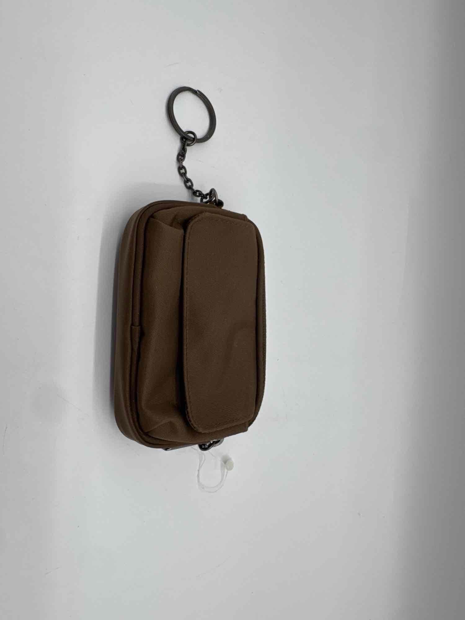 DKNY Mini Keychain Pouch: Vintage DKNY brown mini pouch with a keychain attachment. Features a front flap pocket and zippered main compartment. Interior lined with black fabric and branded with a stitched DKNY tag, marked Made