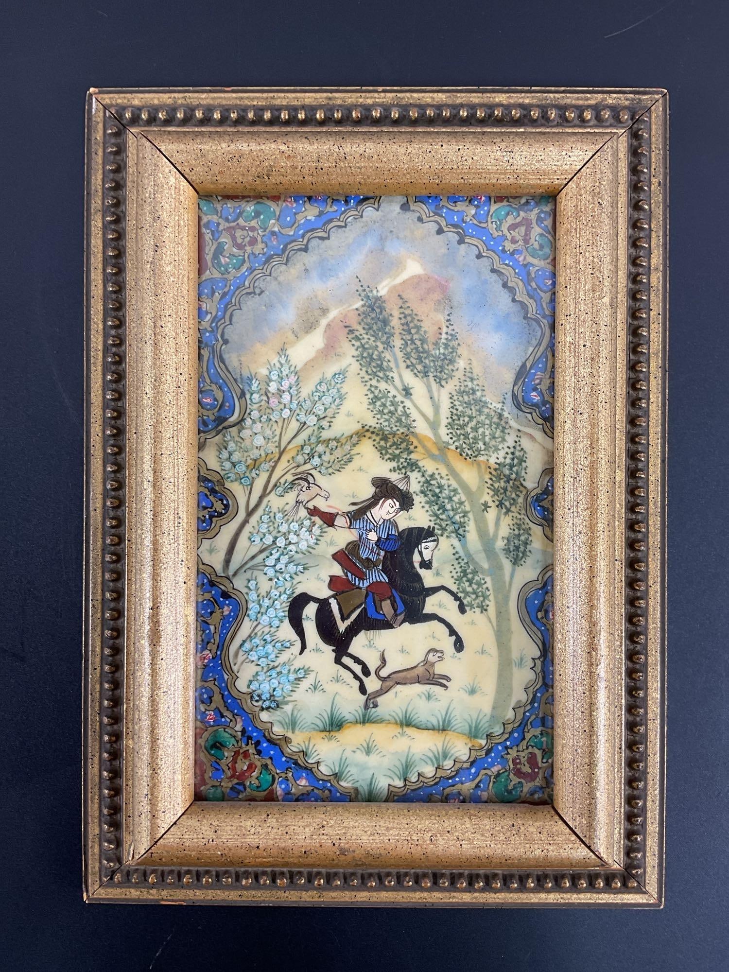 Persian Miniature Painting of a Hunter on Horseback: This framed artwork is a traditional Persian miniature painting featuring a hunter on horseback, depicted in a classic Persian style with intricate details and vibrant colors. The scene showcases the 