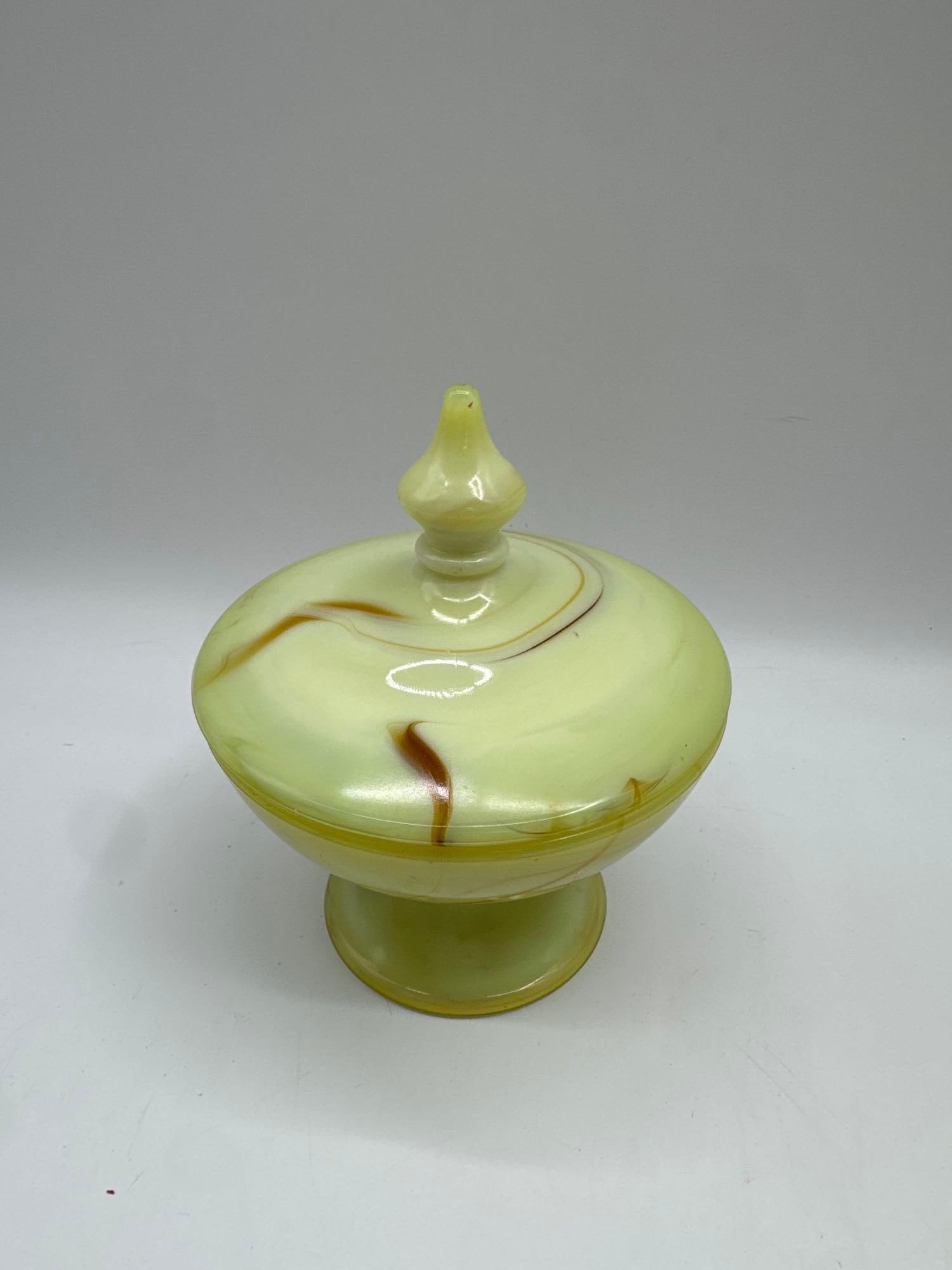 Vintage Art Glass Covered Compote Dish: Elegant pedestal compote dish with lid, crafted from marbled art glass in a soft yellow tone with swirls of amber brown. Features a finial top and smooth glossy finish. Likely mid-20th century, this p