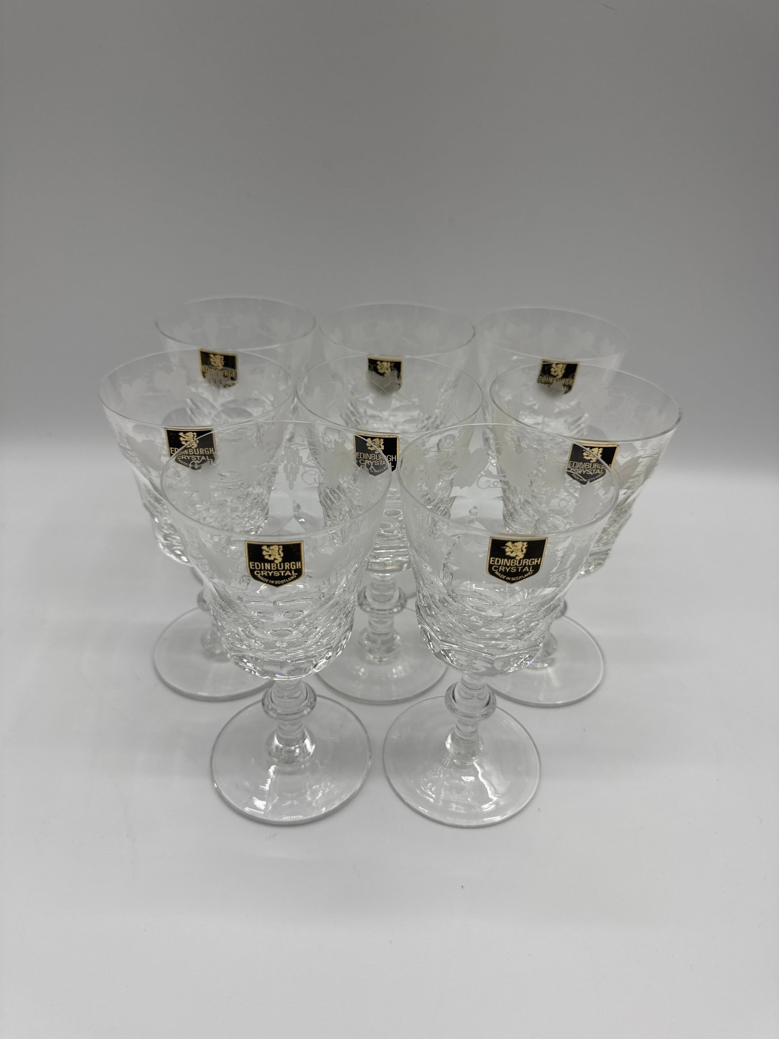 Set of Eight Edinburgh Crystal Wine Glasses: Set of eight Edinburgh Crystal wine glasses. Each glass features a cut crystal design with etched Lochnivar pattern. Original labels present.