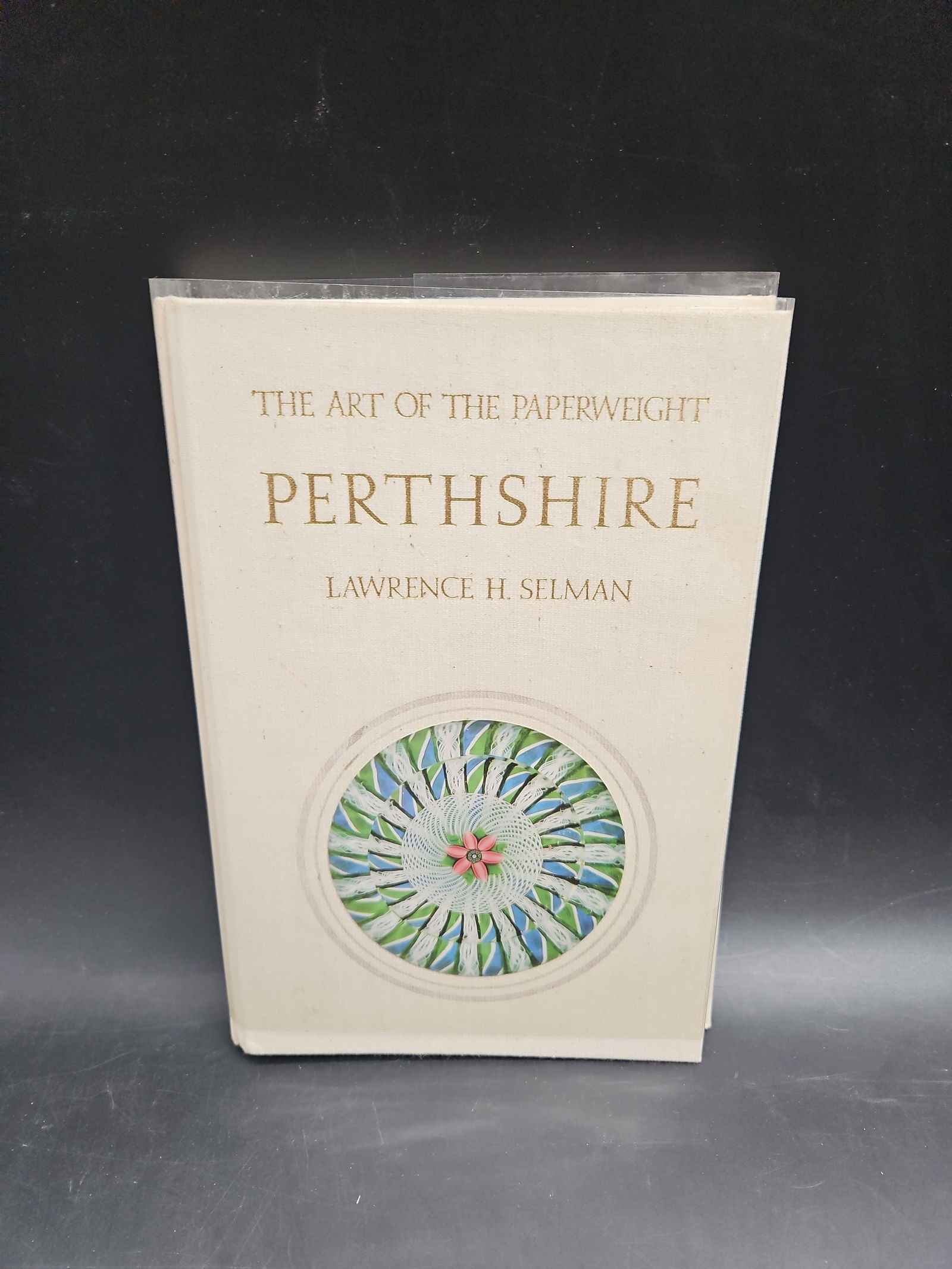 The Art of the Paperweight – Perthshire: A hardcover illustrated volume dedicated to Perthshire Paperweights, showcasing the artistry and craftsmanship of the renowned Scottish glassmakers. The book provides detailed photographs, historical