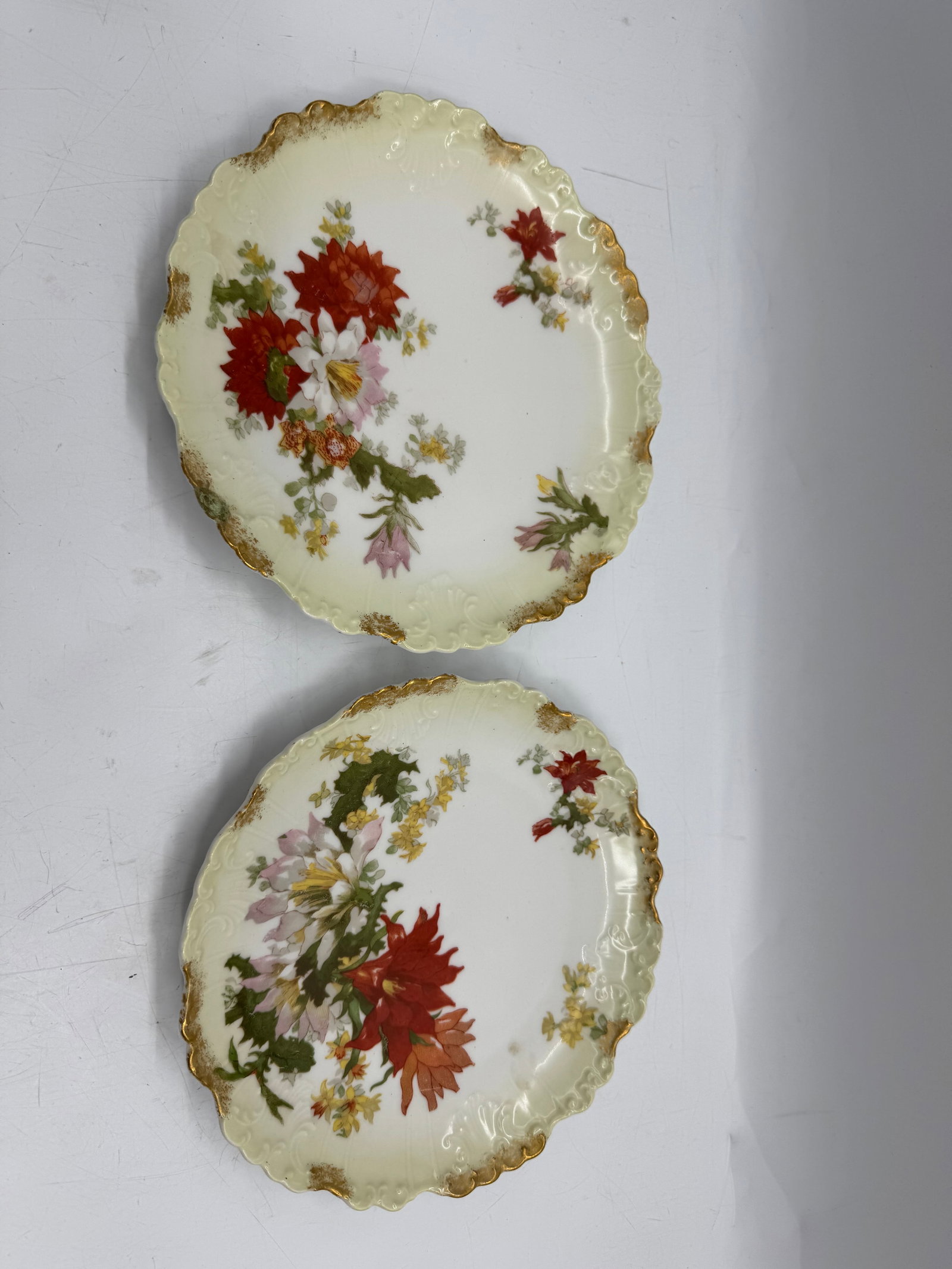 Pair of G.D.A. Limoges Floral Plates: Pair of G.D.A. Limoges porcelain plates, each approximately 9 inches in diameter. Features a scalloped, gilt-edged rim and floral decoration.
