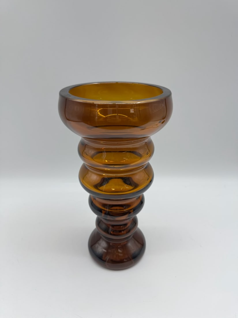 Vintage Amber Glass Vase with Ribbed Design: Vintage amber glass vase featuring a unique ribbed design. The vase has a bulbous shape with a wide opening, perfect for displaying flowers or as a standalone decorative piece. The warm amber color ad
