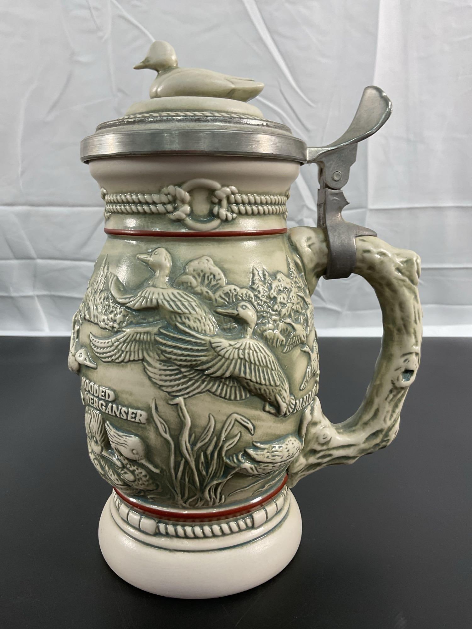 Ducks of the American Wilderness Stein: This beautifully detailed beer stein, titled "Ducks of the American Wilderness," features an intricate design of ducks in their natural habitat, showcasing species such as the Mallard and Re