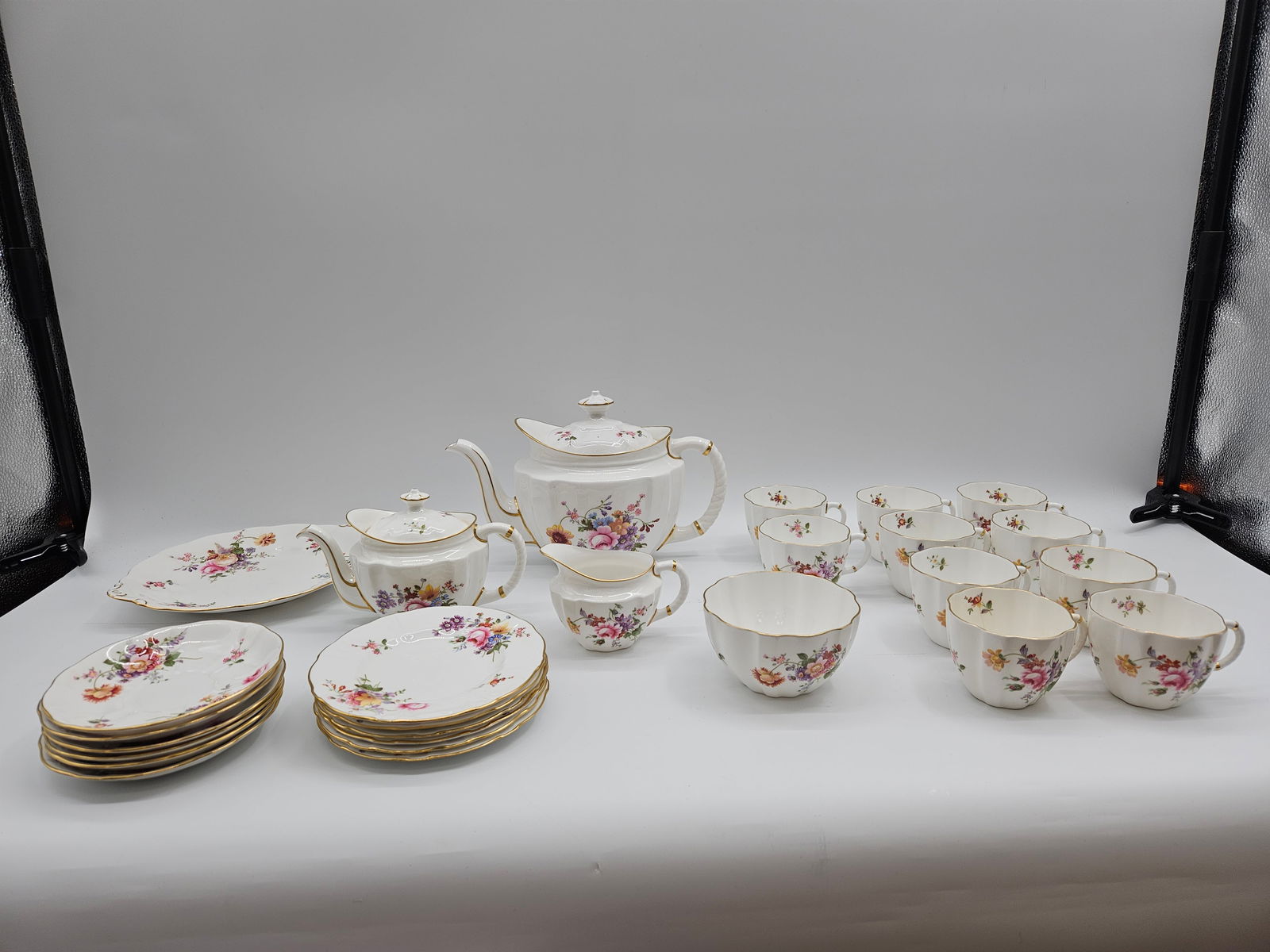 Royal Crown Derby Fine Bone China – Derby Posies Pattern Set: Collection of fine bone china in the Derby Posies floral pattern, including teacups, saucers, plates, and covered serving pieces. Elegant English design with multicolor floral decoration and gilt trim