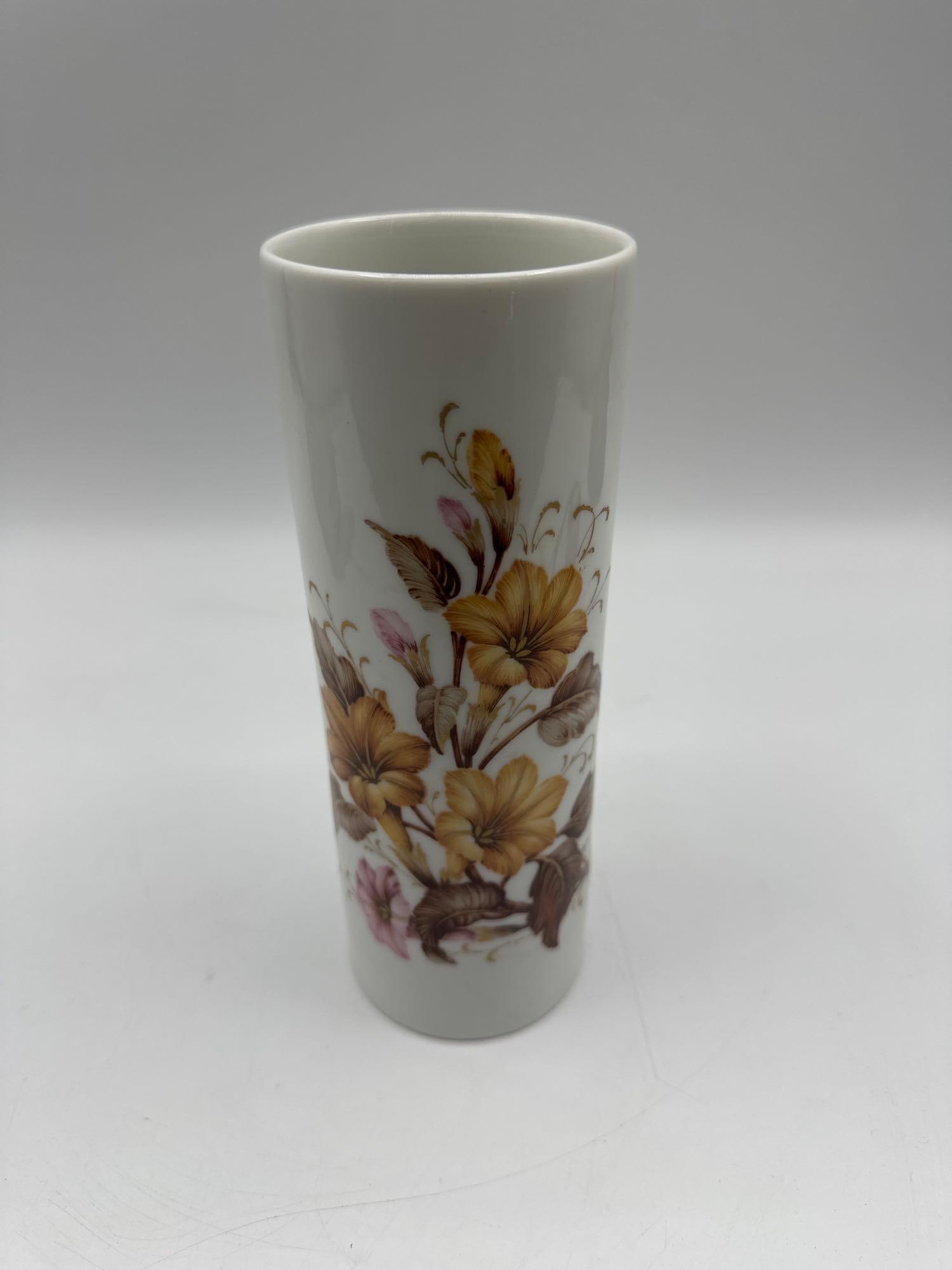 Kaiser Porcelain Vase by K Nossek: White porcelain vase decorated with hand-painted yellow, brown, and pink floral motifs. Designed by K Nossek for Kaiser Porzellan, Germany. Marked “Arlette” on the base. Medium Porcelain D