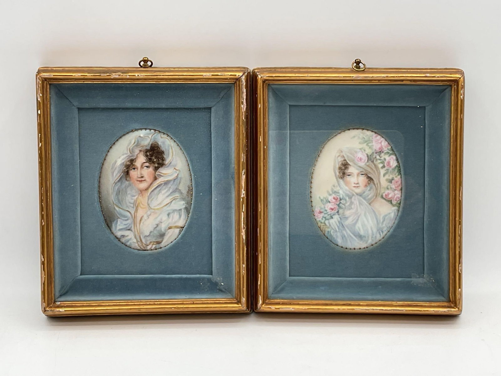 Miniature Portraits: Marie Antoinette and Elizabeth of France: This is a pair of antique portrait miniatures, likely reproductions, depicting Marie Antoinette and her sister-in-law, Élisabeth of France. The left portrait shows a young woman in a fur-trimme