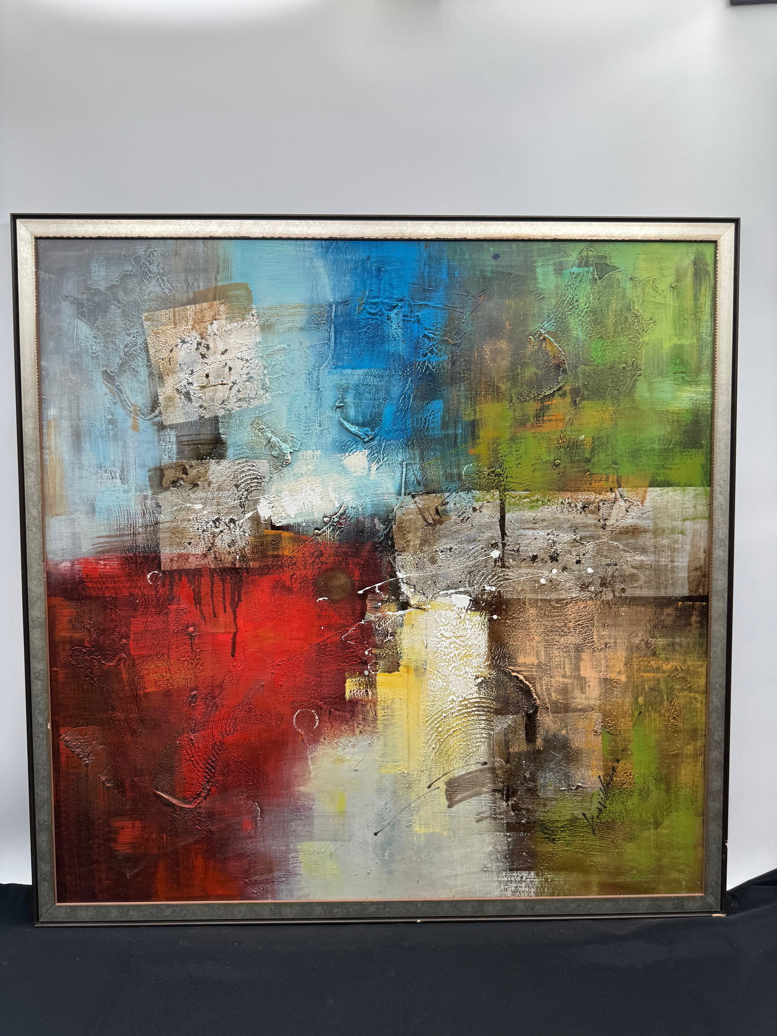 Abstract Mixed Media Painting, 35.5 x 35.5 in: Abstract mixed media painting featuring a vibrant color palette of red, blue, green, and yellow. The work incorporates textured elements and geometric shapes, creating a dynamic and visually engaging 