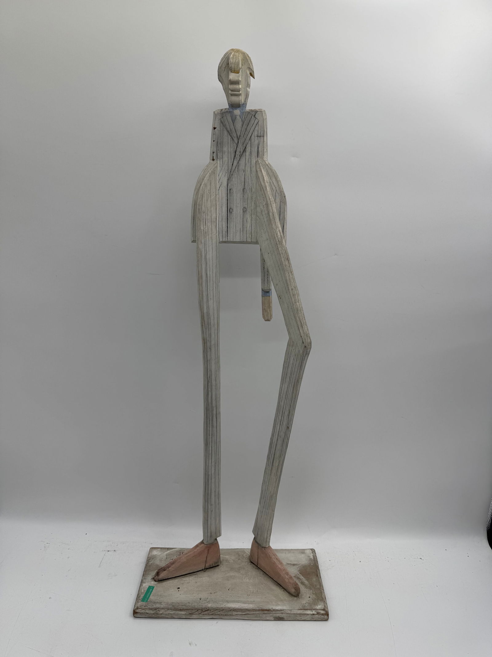 Joe Brubaker, American Postwar & Contemporary Artist: Painted wood figure of a stylized human form. Mounted on a rectangular base. Dimensions: 39 x 14 x 7 inches.
