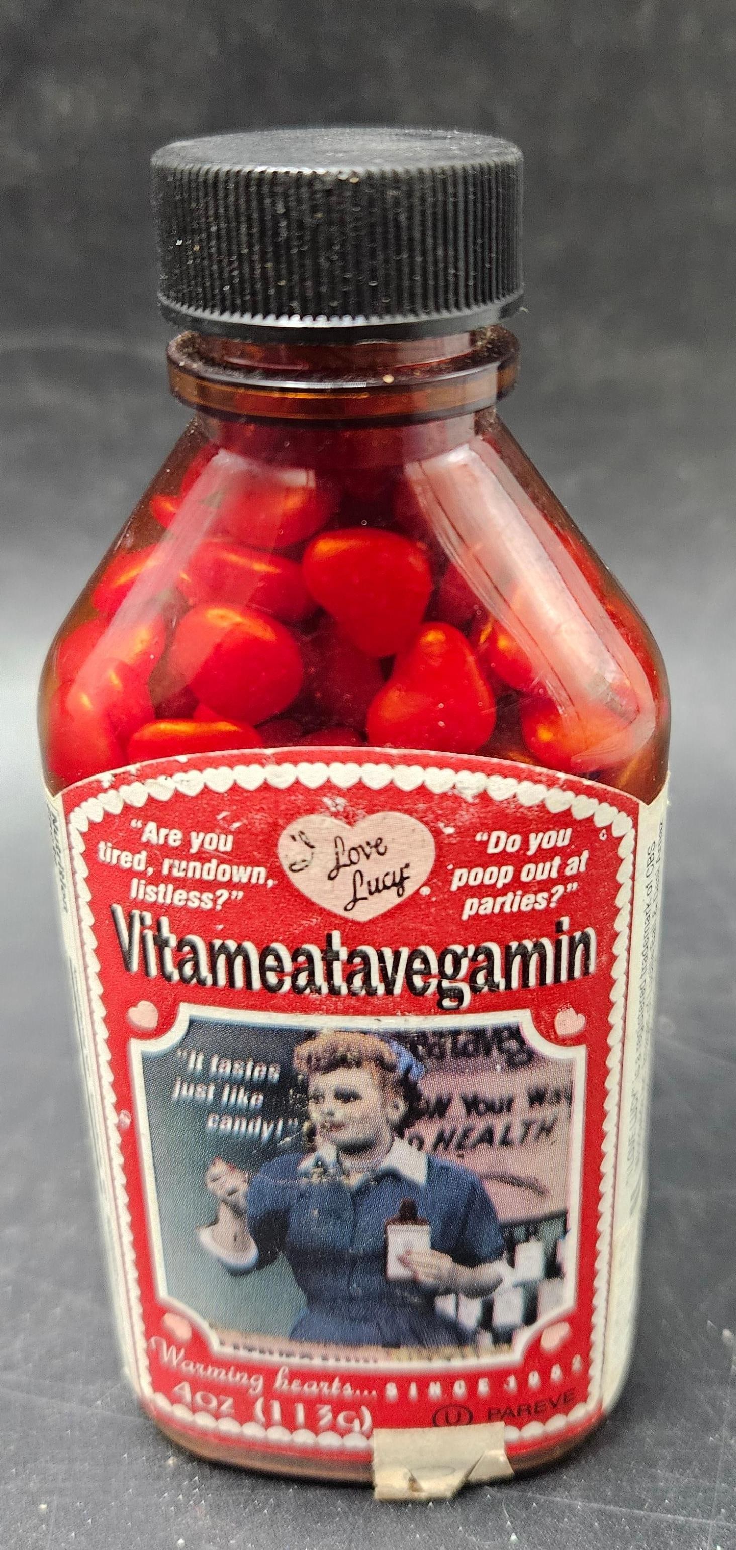 I Love Lucy Candy Hearts: Collectible candy container themed after the classic television show I Love Lucy, shaped as a heart or featuring heart-shaped candies. Packaging highlights the iconic Lucy character, making it a nosta