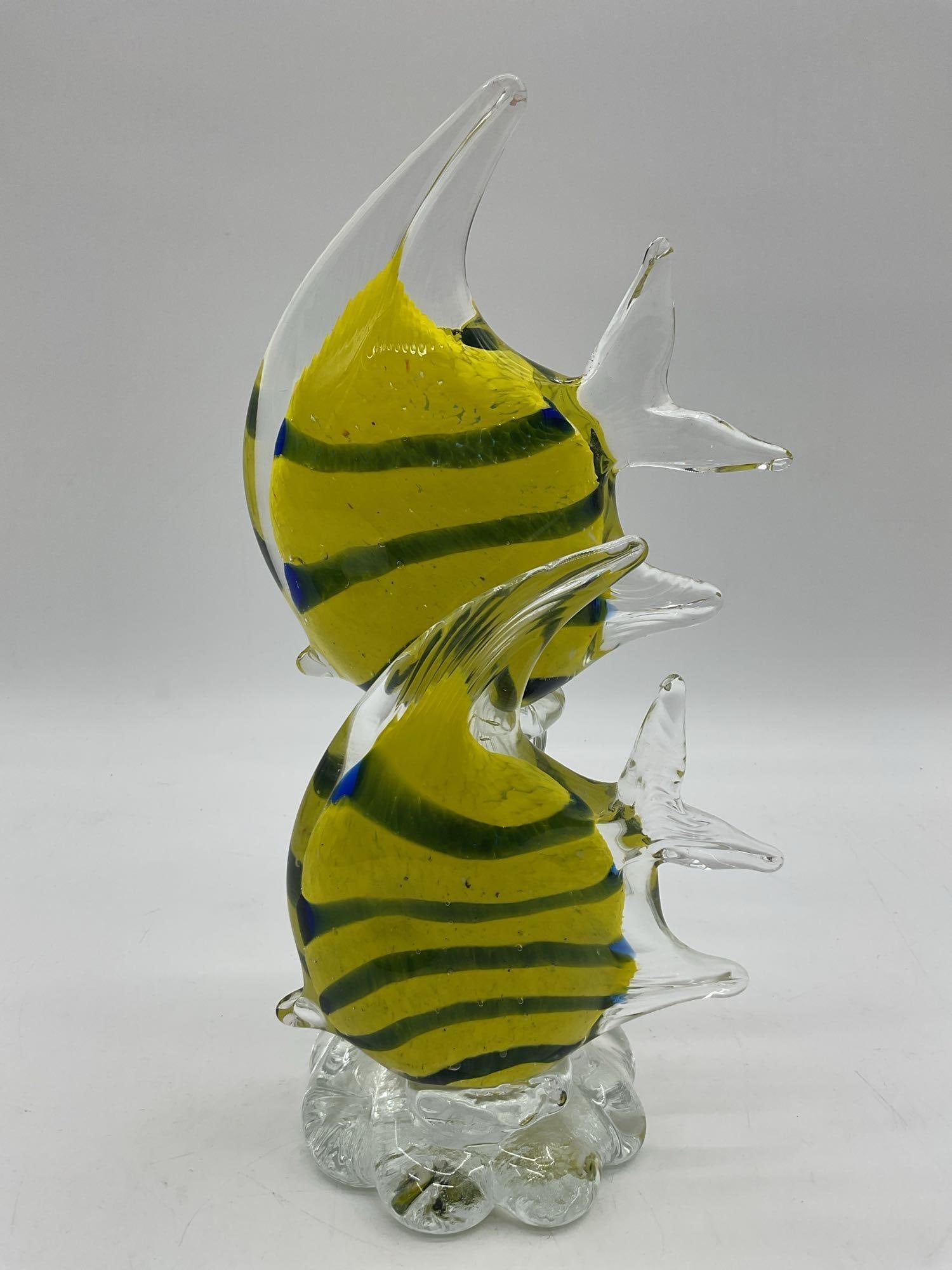 Giorgio Guzman Murano-Style Glass Sculpture of Angel Fish: Hand-blown glass art featuring two yellow and green striped fish swimming upward in a clear wave-like base. Dimensions: H12in L6in W5in Medium: Hand-blown art glass sculpture