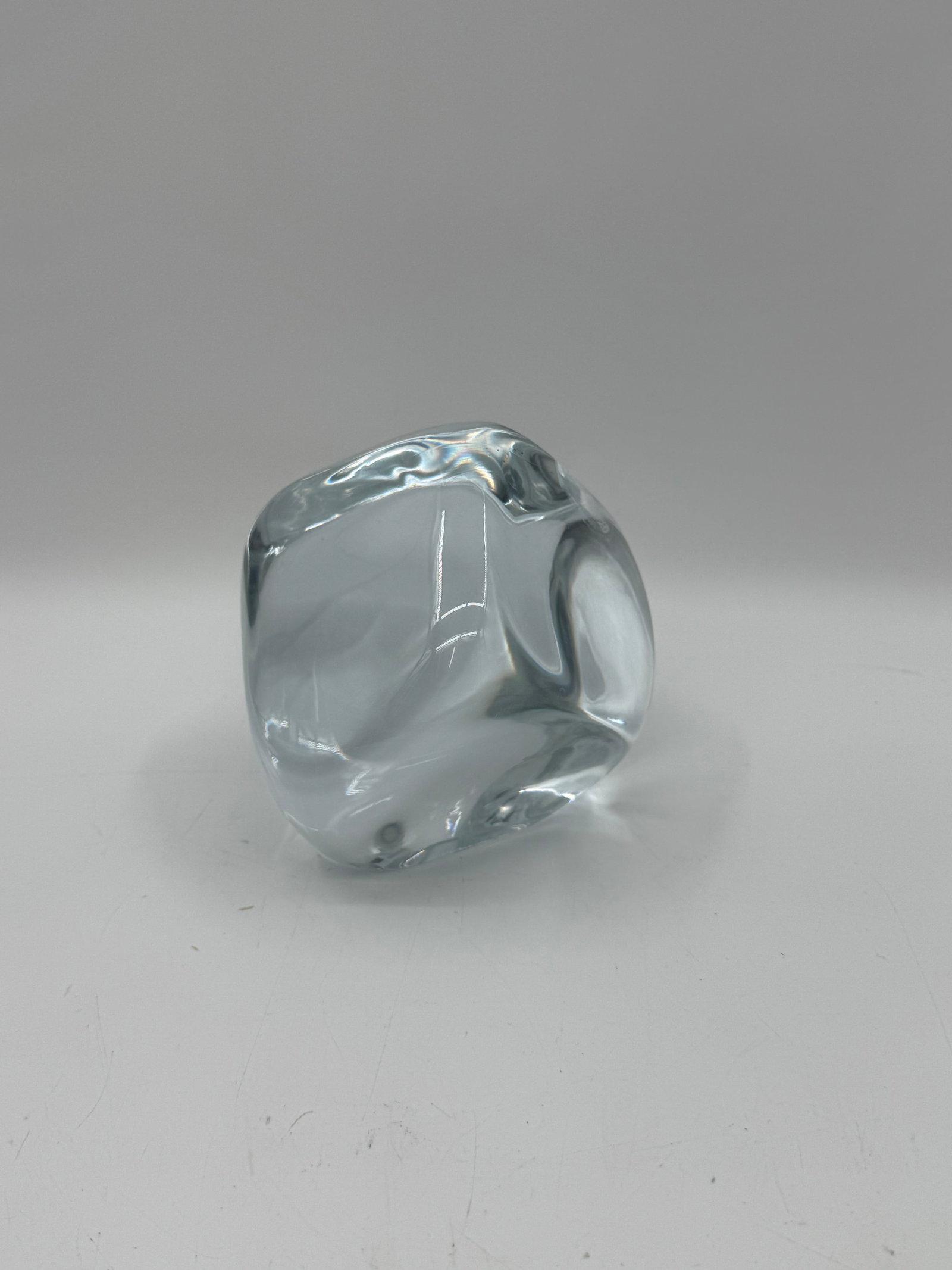 Signed Art Glass Cube: Clear art glass sculpture with an organic, freeform shape. Signed on the side, possibly Kosta Boda. Measures approximately 5 x 4 inches. A beautiful decorative piece.