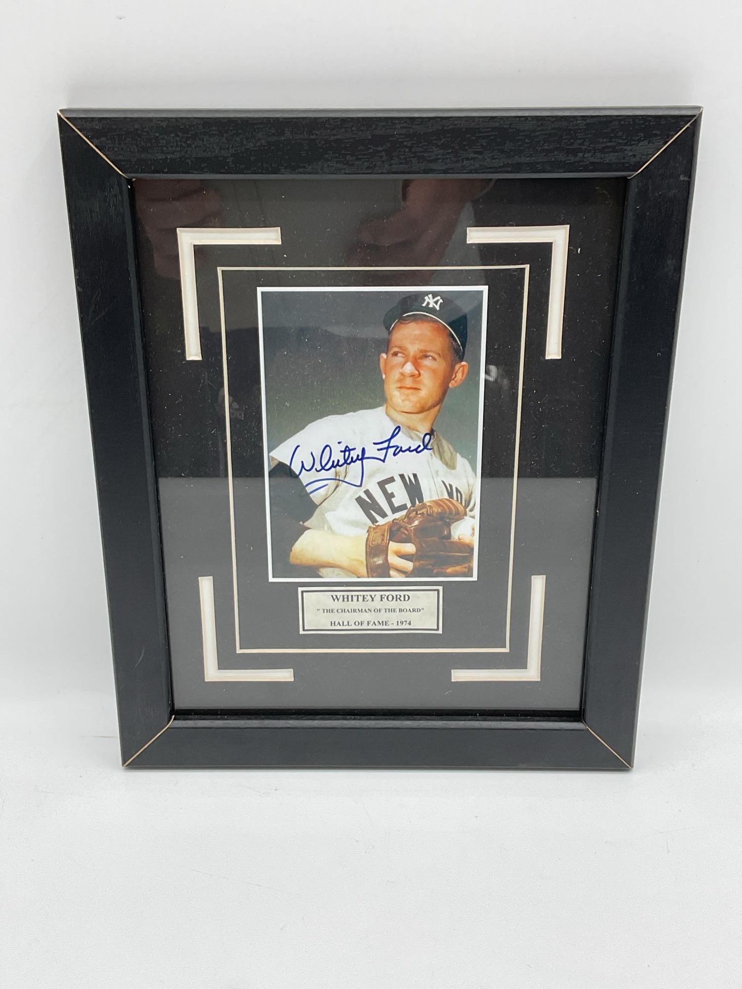 Whitey Ford Signed Yankees Photograph Plaque: Color photograph of Hall of Fame pitcher Whitey Ford in his New York Yankees uniform, hand-signed in blue ink. Presented in a double mat with a metallic nameplate reading: "Whitey Ford - 'The