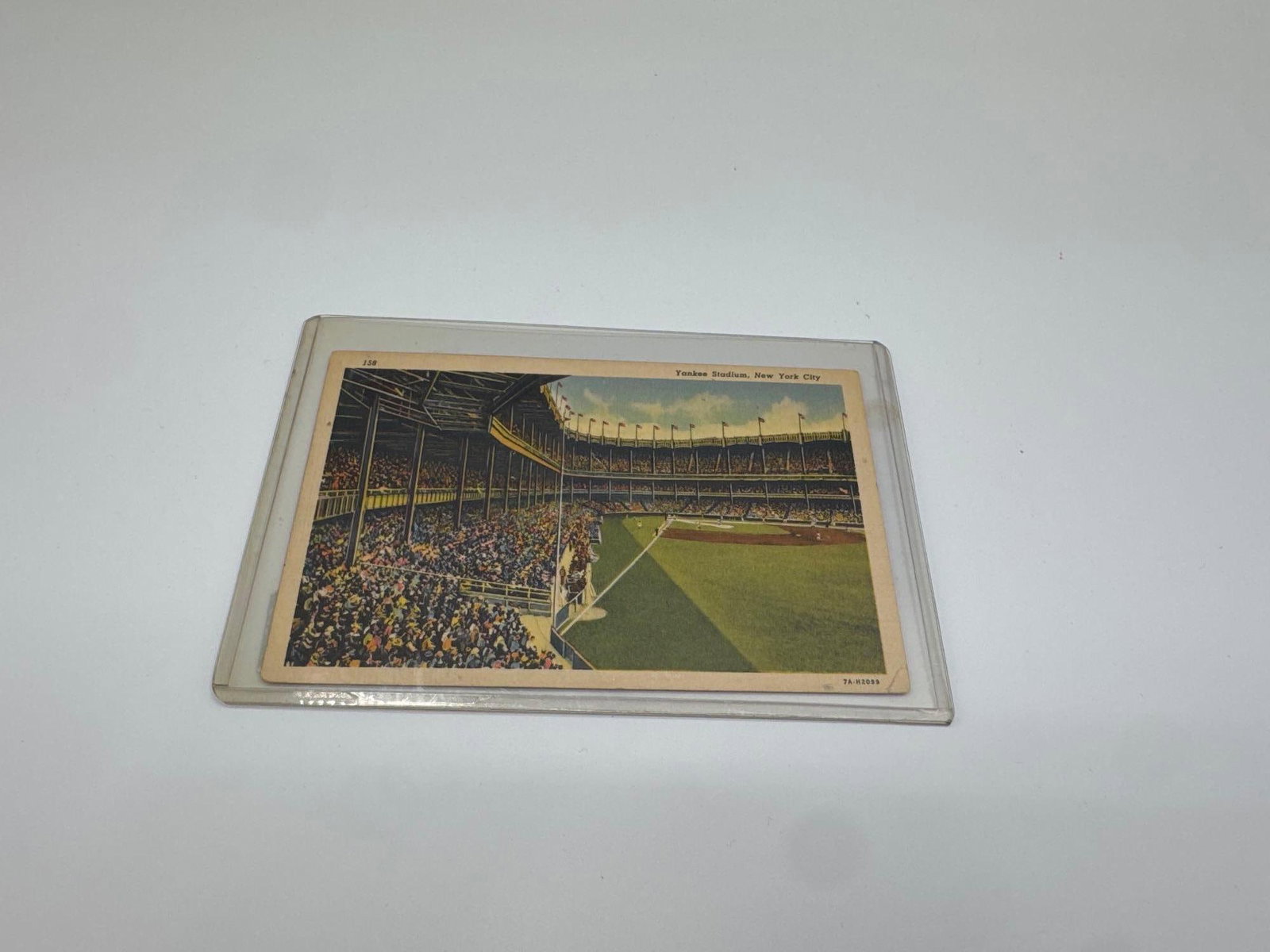 Yankee Stadium Vintage Postcard, New York City: Early 20th-century postcard showing a full crowd inside Yankee Stadium, New York City. The back includes handwritten correspondence and a postal cancellation stamp from Brooklyn, N.Y. It was published