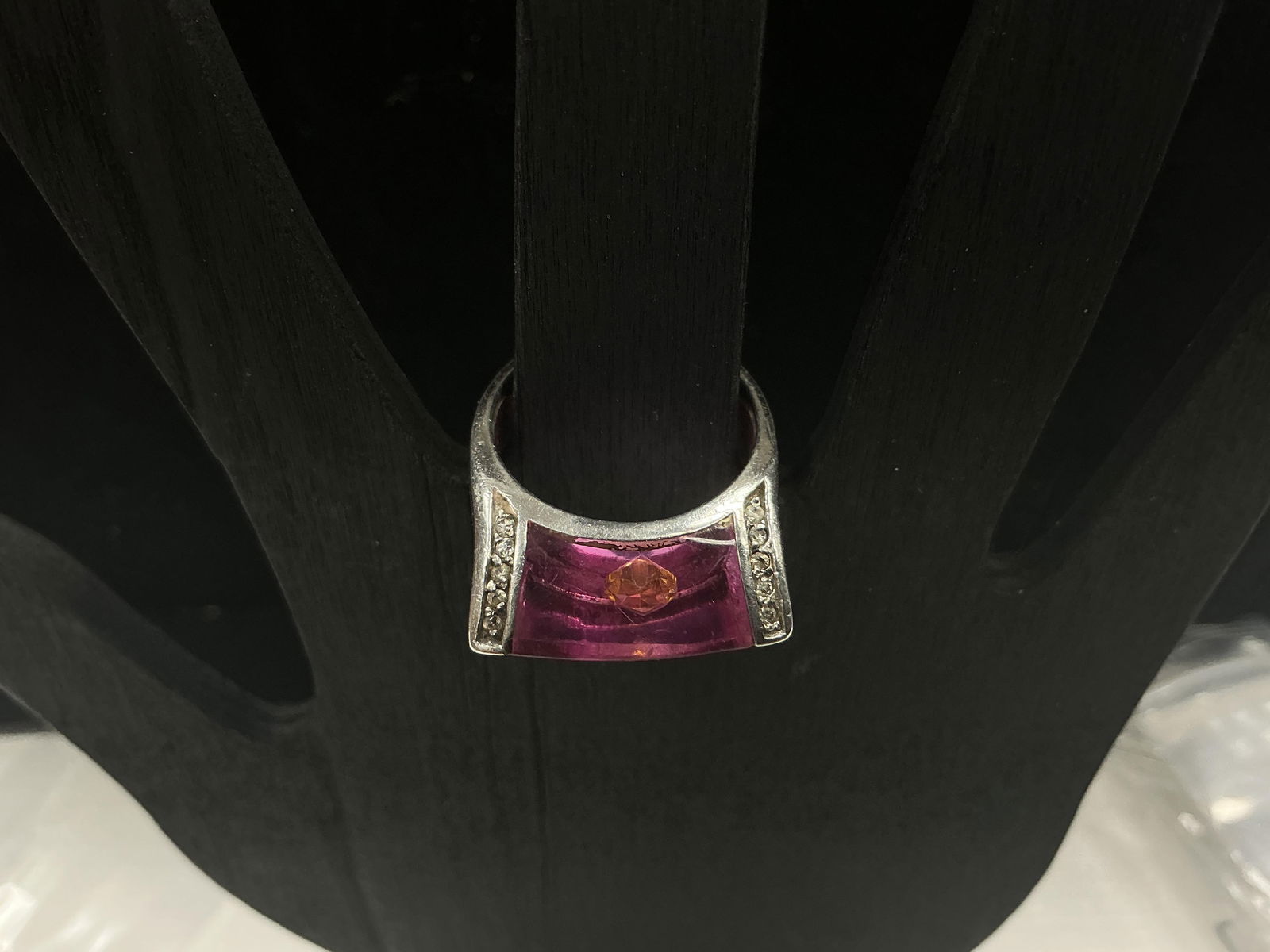 Sterling Silver 925 Ring with Pink Stone, Floating Accent, and CZs – Size 9, 7.95g: Modern statement ring crafted in sterling silver, stamped 925, featuring a bold rectangular pink stone centerpiece with a unique floating stone suspended inside. Additional cubic zirconia accents are