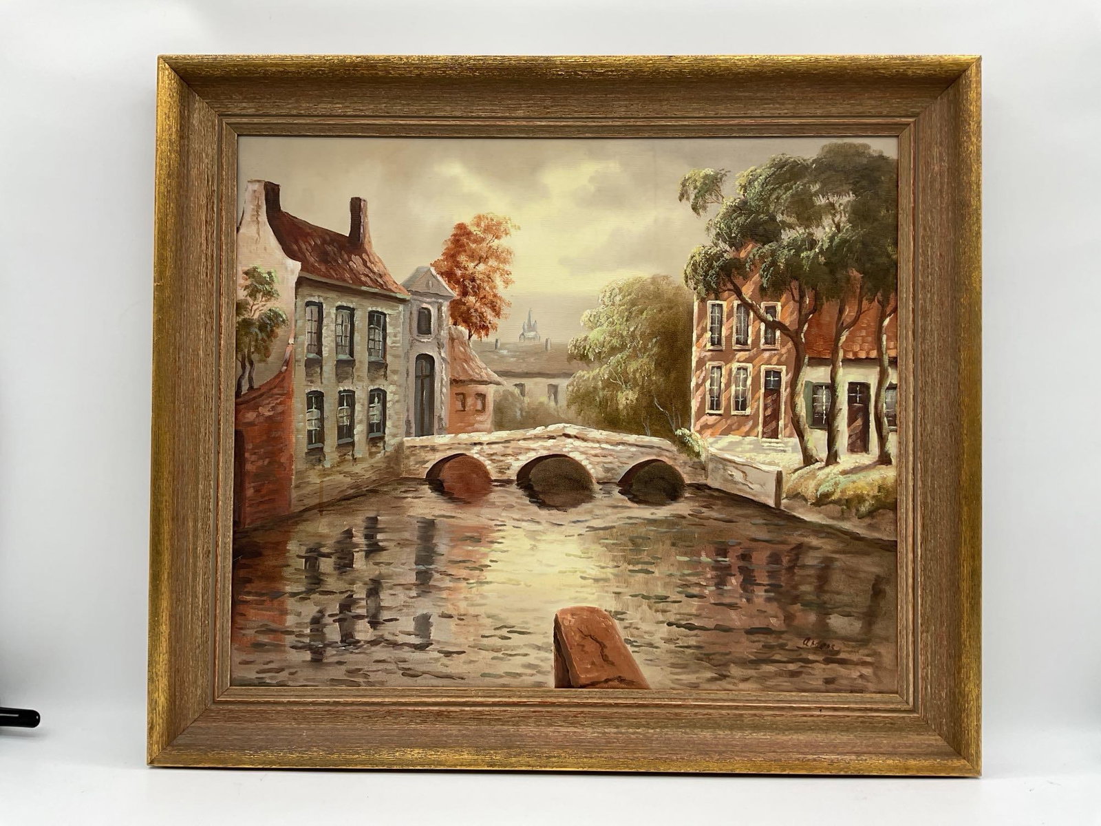 European Canal Scene by Andres Oil on Canvas: Serene view of a stone bridge crossing a quiet canal lined with historic buildings and trees, with reflections shimmering in the water Dimensions: H:26in L:30in Medium: Oil on canvas