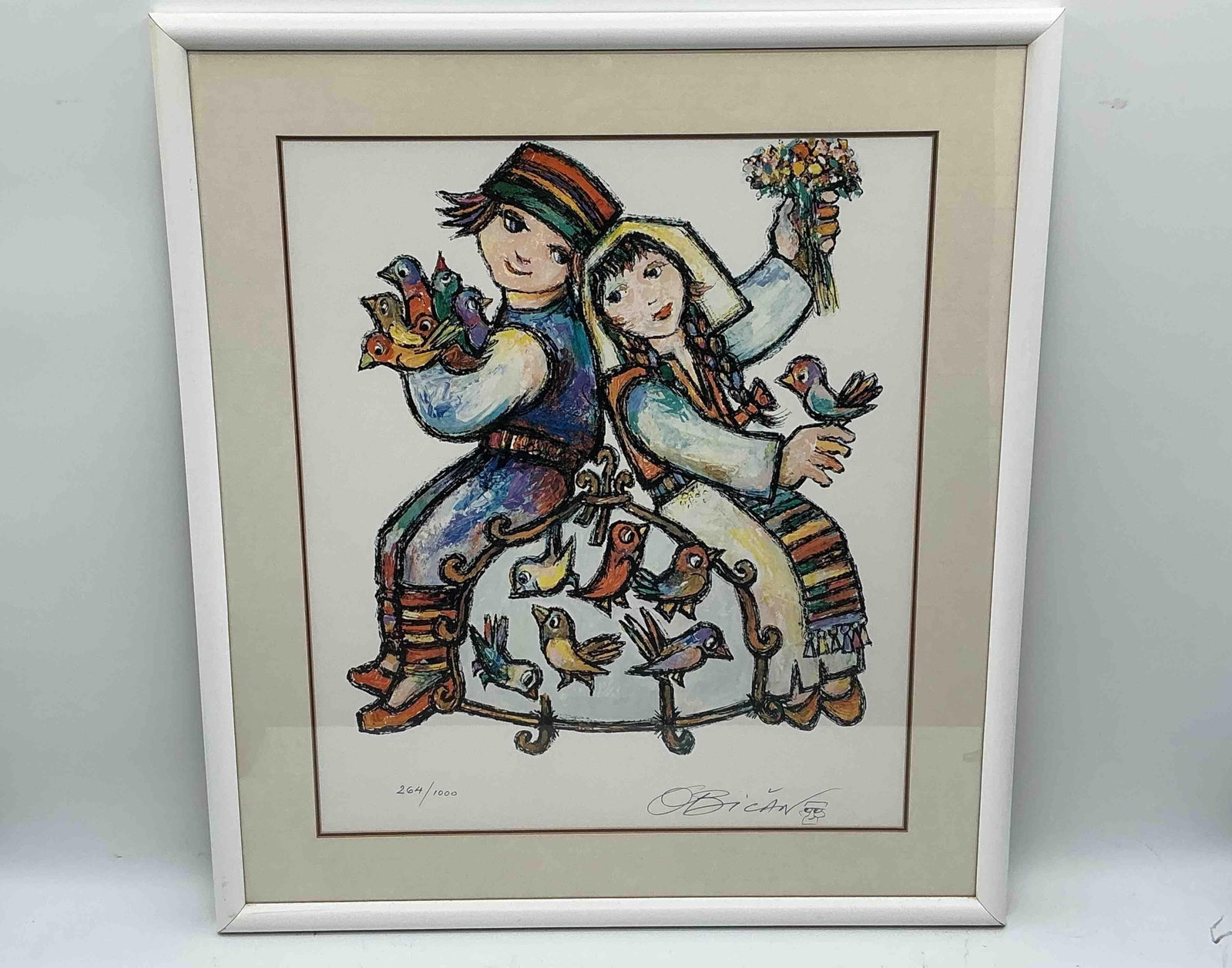 Jovan Obican Limited Edition Lithograph – Children with Birds: Charming limited edition lithograph by Jovan Obican (1918–1986), depicting two children in colorful folk attire surrounded by birds. Obican, often called the "happy artist," is celebra