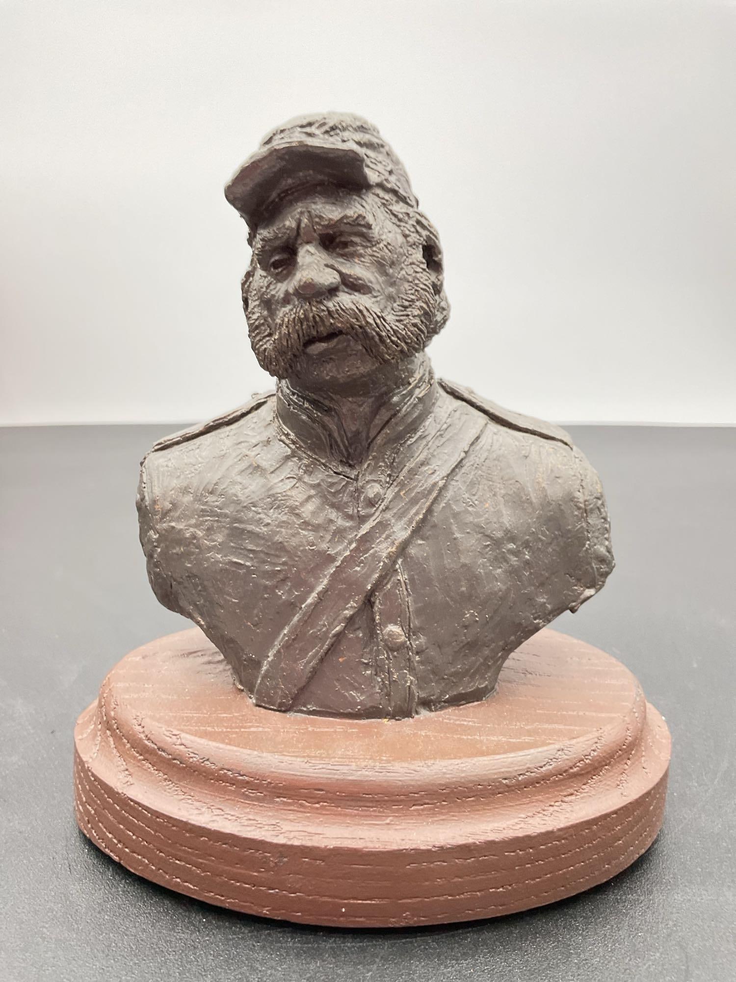 Civil War Union Soldier Bust Sculpture:  This is a finely crafted bust sculpture of a Union soldier, possibly depicting a specific Civil War officer or a generic representation of a battle-worn infantryman. The soldier is shown with a 