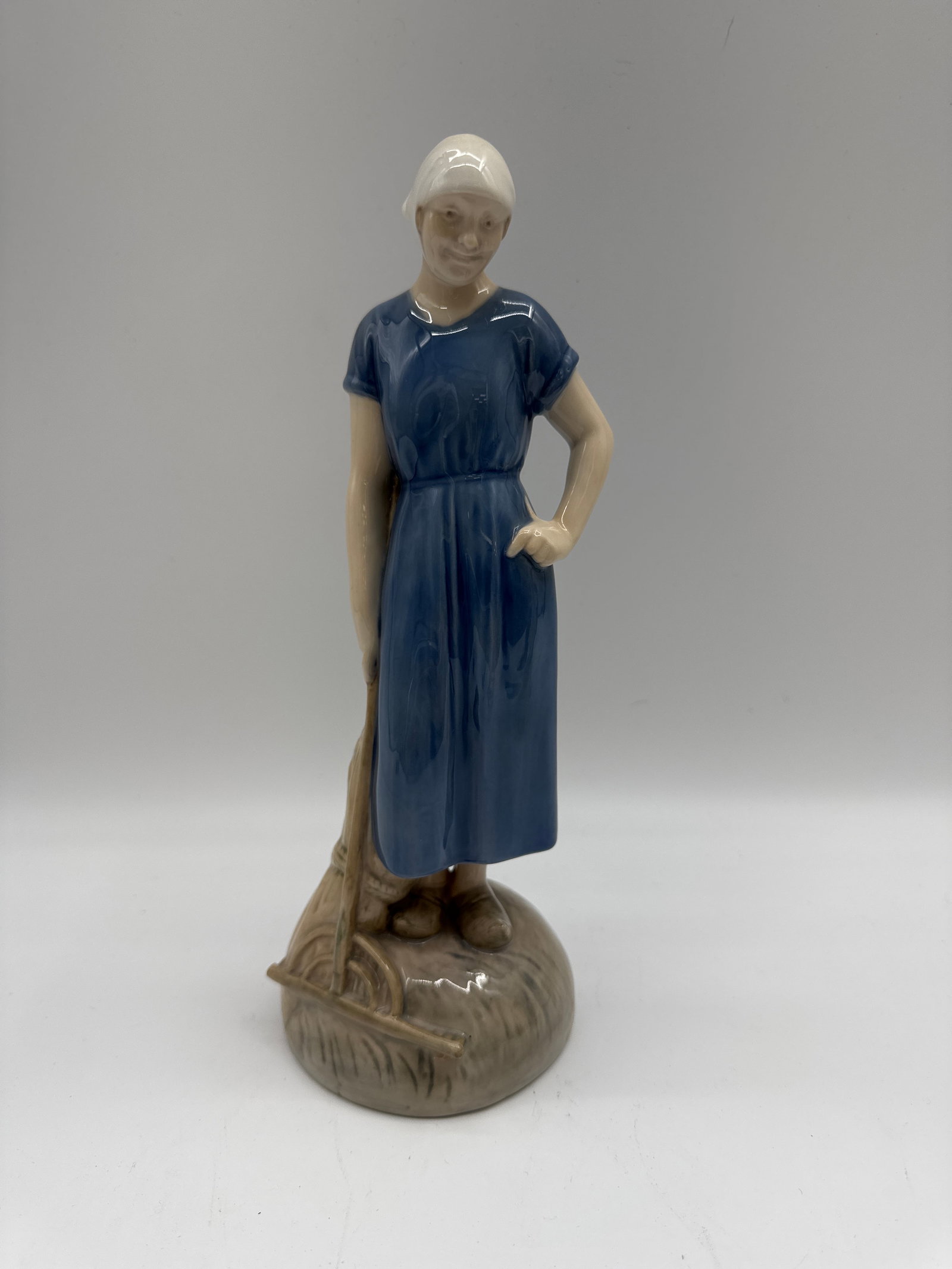 Royal Copenhagen Porcelain Figurine - Woman with Sheep: Vintage Royal Copenhagen porcelain figurine of a woman with a sheep, designed by Axel Locher. Marked on the base with the Royal Copenhagen mark and artist signature.