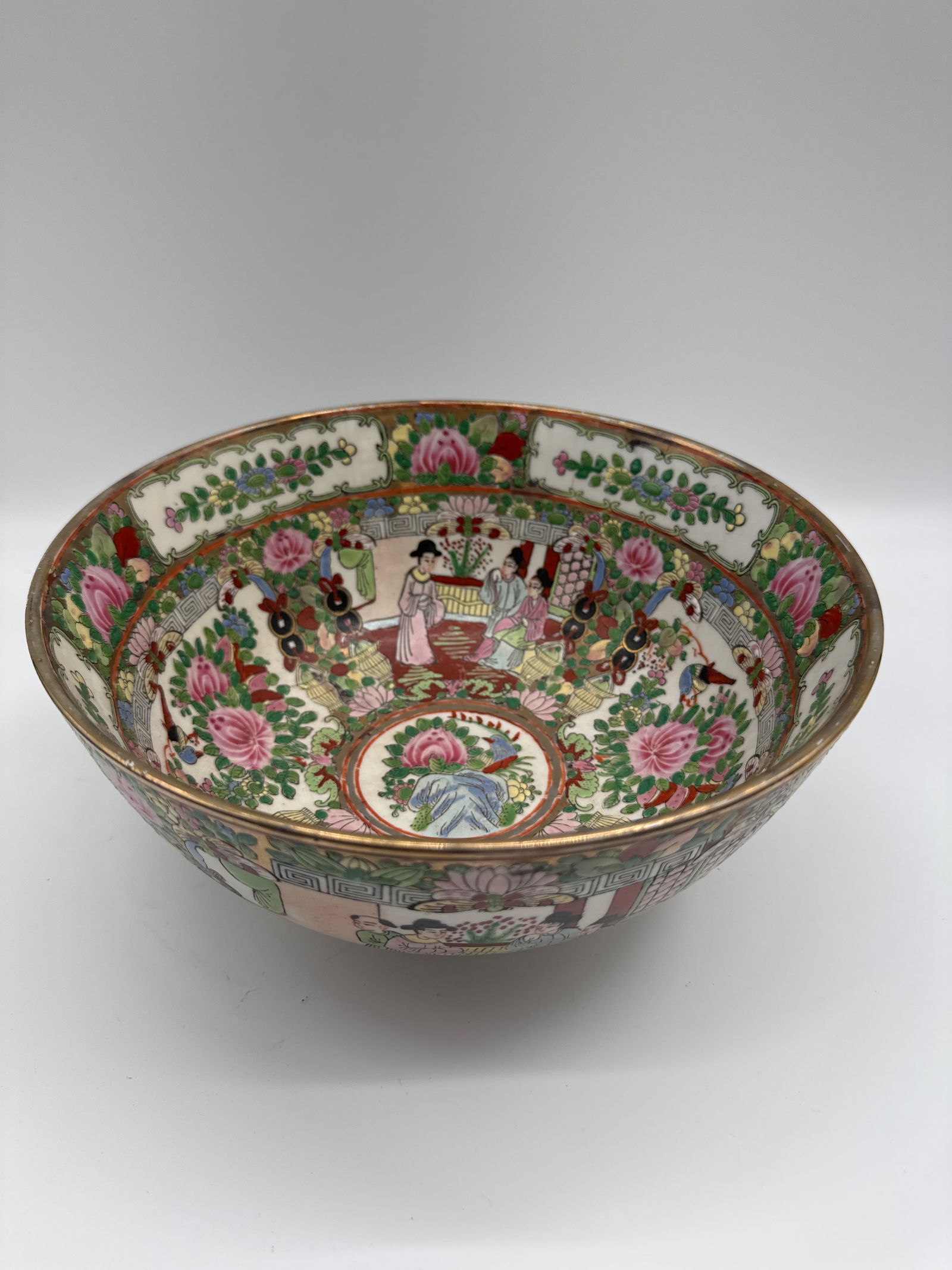 Antique Asian Famille Chinese Rose Medallion Porcelain Bowl: Antique Chinese Famille Rose porcelain bowl. The bowl features a vibrant and detailed design with figures, birds, and floral motifs. The rim is trimmed with gold. The base has a red stamp. Late 19 cen