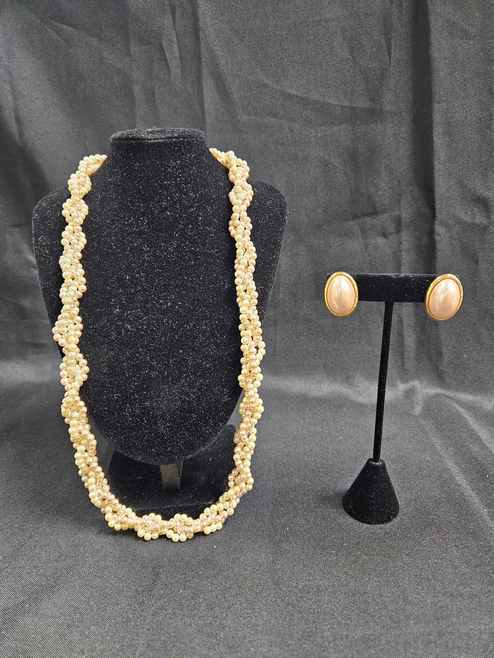 Vintage Trifari Faux Pearl Necklace and Earrings Set: Vintage Trifari jewelry set including a faux pearl necklace and matching earrings. The necklace features a multi-strand design. The earrings are clip-on style with gold-tone backs. Marked 'Trifari