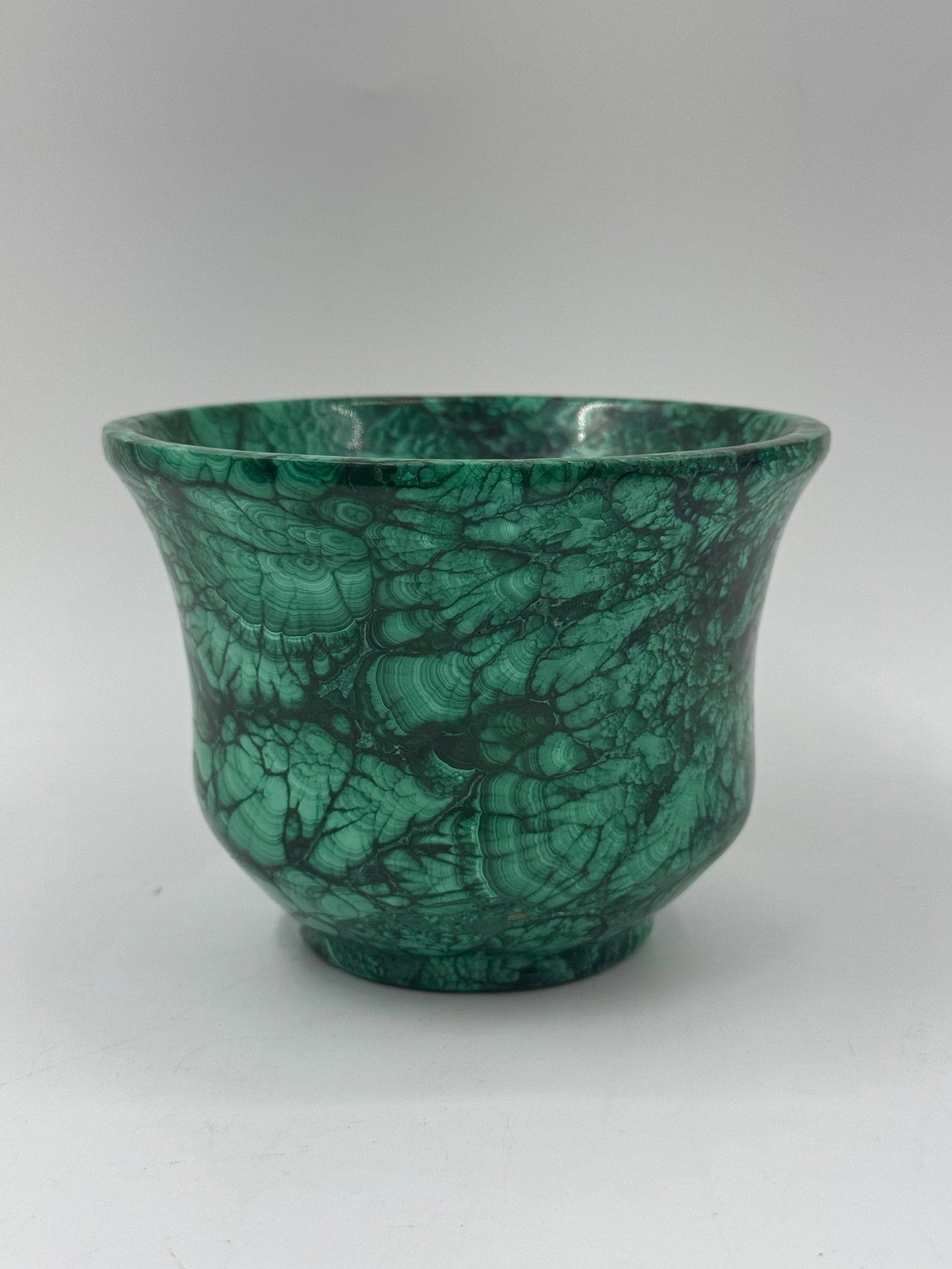 Malachite Bowl: A malachite bowl, approximately 4 inches tall and 5 inches in diameter. The bowl features a vibrant green color with characteristic malachite banding and patterns.