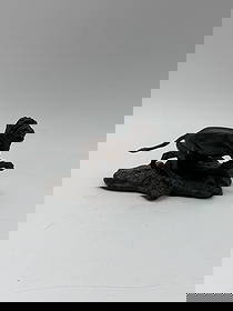 Franklin Mint Bronze Lion Sculpture: Bronze sculpture depicting a lion attacking its prey. Marked '1976 R. HANA' on the base. Marked 'Lion (Panthera leo) Bronze The Franklin Mint' on the underside. Measures approximately