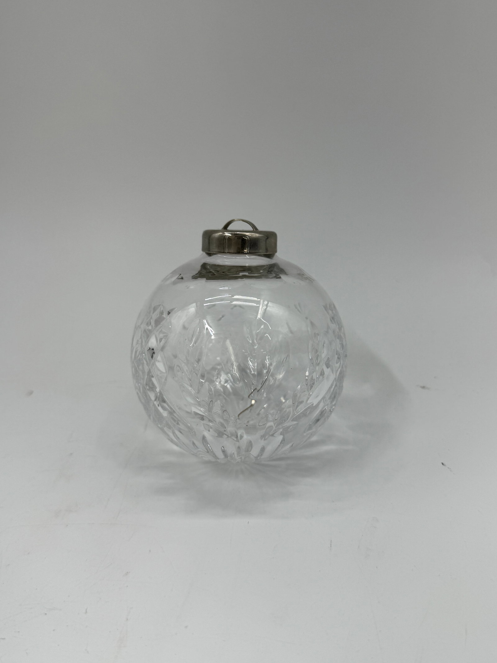 Wedgewood Crystal Glass Christmas Ornament: Clear crystal glass Christmas ornament with a faceted design and metal loop for hanging. Measures approximately 3.5 x 2.5 inches.