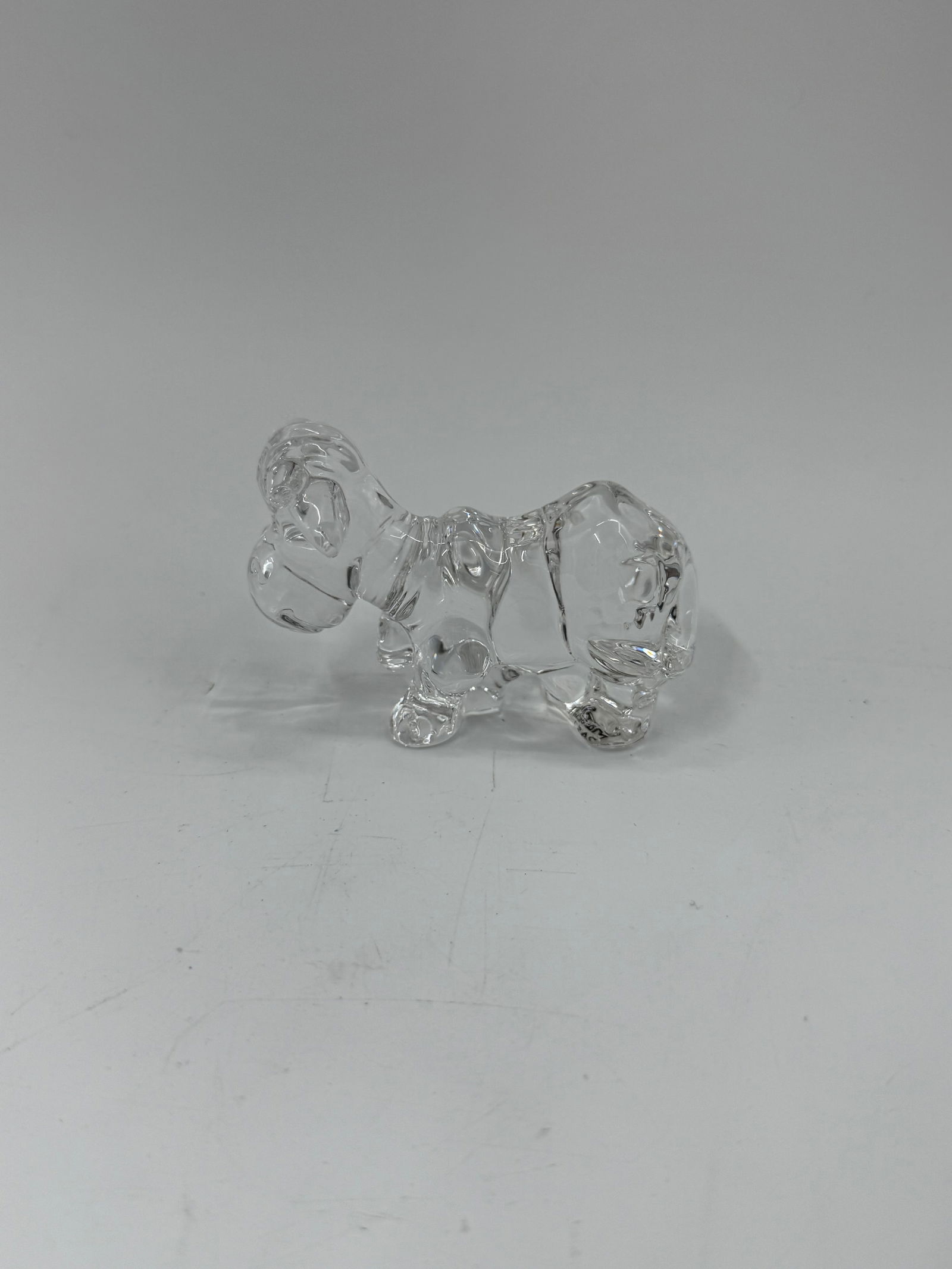 Goebel Crystal Dog Figurine: Clear lead crystal figurine depicting a playful dog, finely detailed and signed by Goebel of Germany. Retains original label reading “Goebel W. Germany, 24% Lead Crystal.” 3x2in