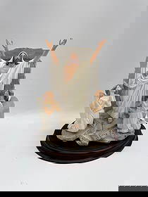 Resurrection Sculpture - Franklin Mint: Resin sculpture depicting the Resurrection. Features Jesus Christ with angels, mounted on a wooden base. Dimensions: 10 x 6 x 10 inches.