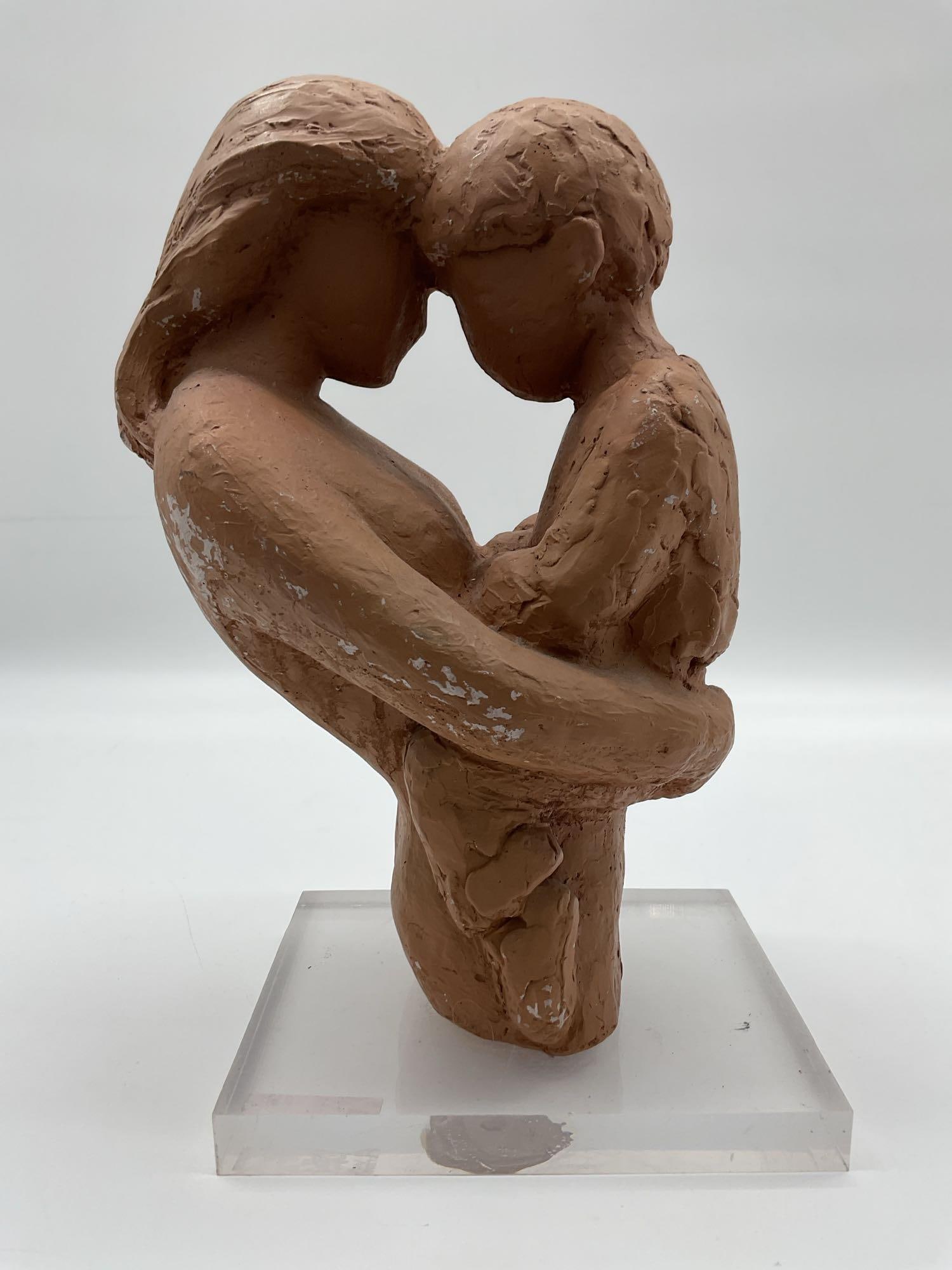 Mother and Child Embrace Sculpture by Klara Sever(Czech, b.1935): Expressive modernist sculpture depicting a faceless mother tenderly holding her child, heads touching in a gesture of intimacy and protection. Dimensions: H12in L9in W6in Medium: Painted terracotta on