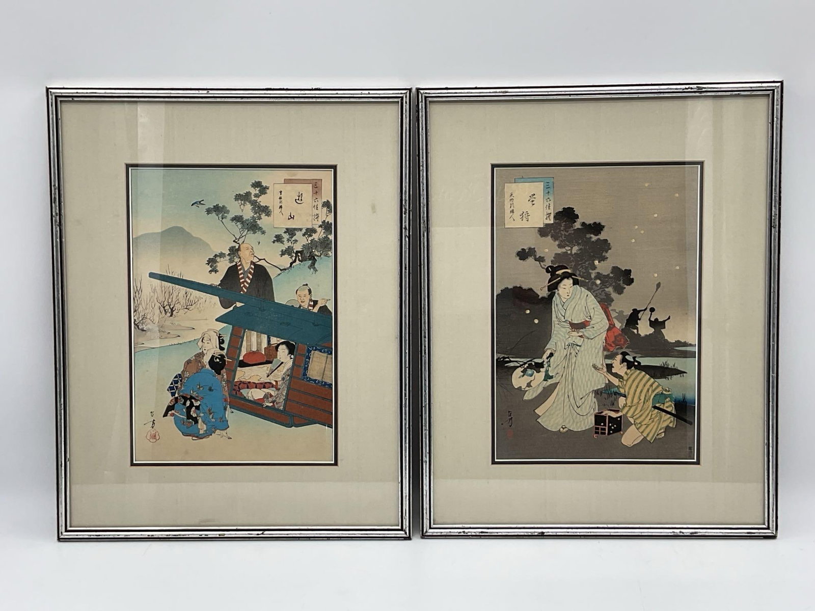 Pair of Framed Japanese Woodblock Prints: Pair of framed Japanese woodblock prints depicting scenes with figures in traditional settings. Each print is framed. Dimensions: 19 inches high, 15 inches long.