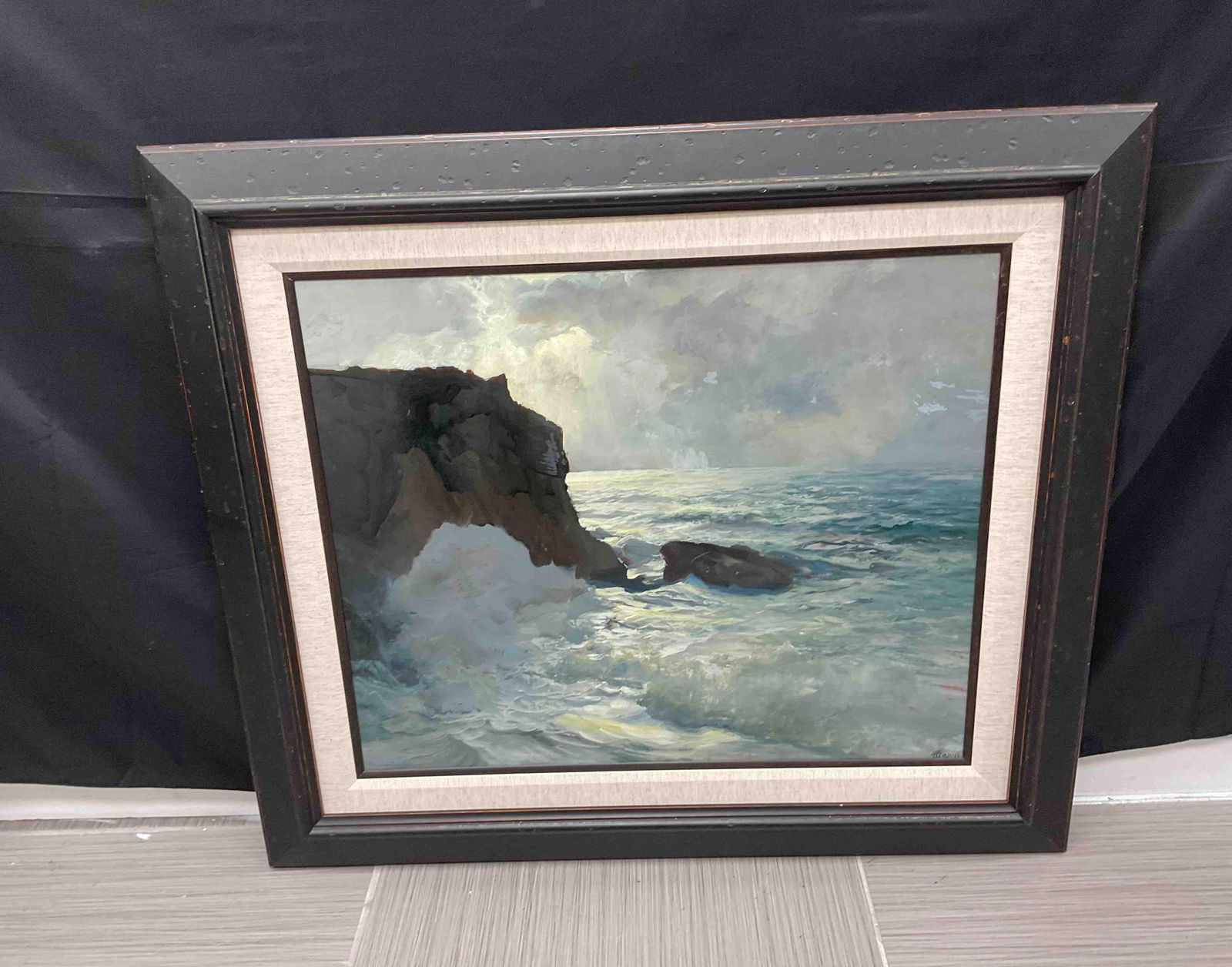 Frederick Judd Waugh (American, 1861-1940): Description: Framed seascape painting depicting dramatic ocean waves crashing against rocky cliffs under a moody sky. The piece conveys movement and atmosphere, highlighting the power of nature. By Ne