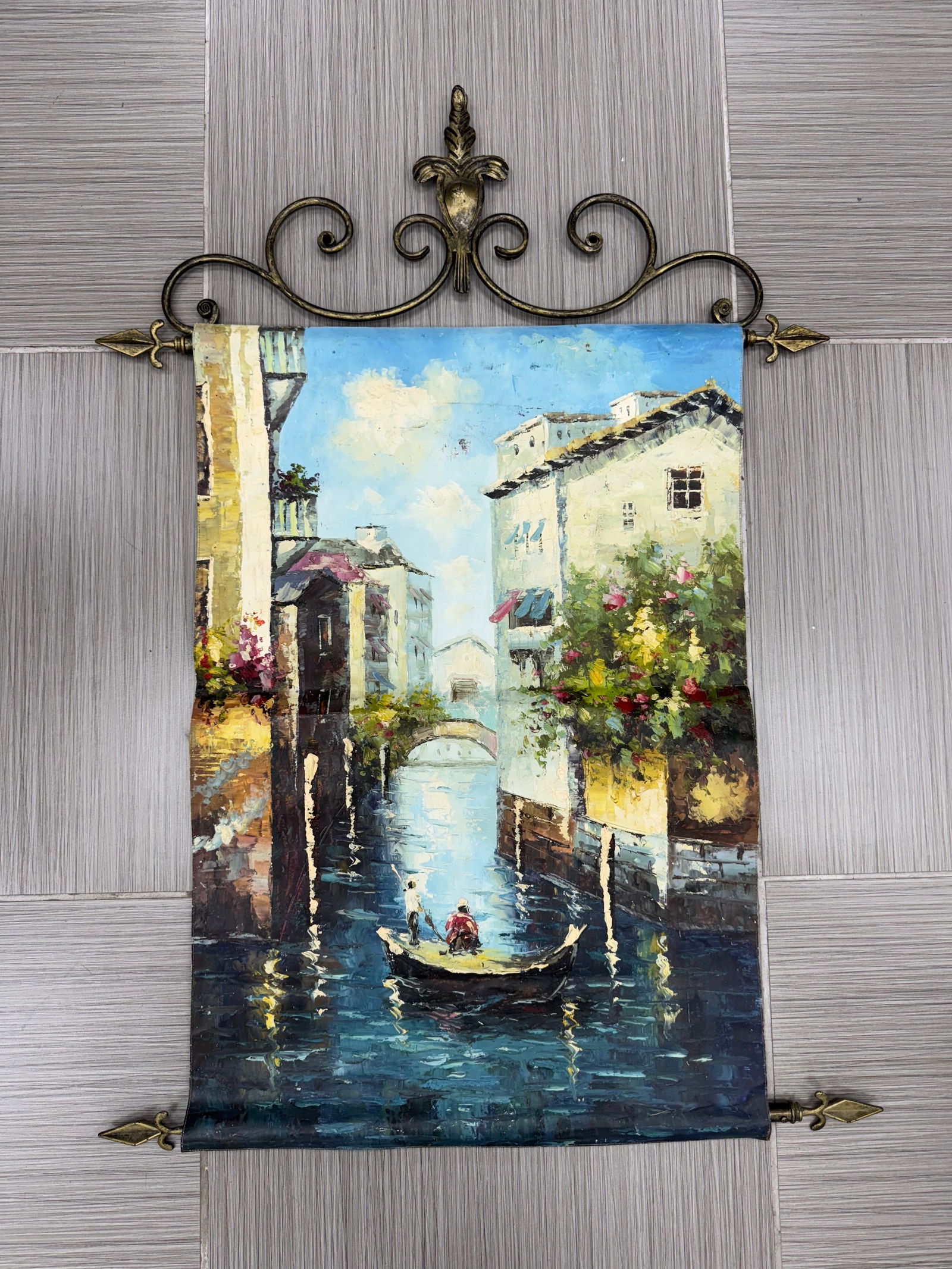 Venetian Canal Scene Oil Painting on Fabric Scroll: Oil painting on fabric depicting a Venetian canal scene with buildings and a gondola. Mounted as a scroll with decorative metal hardware. Dimensions approximately 46 x 32 inches.